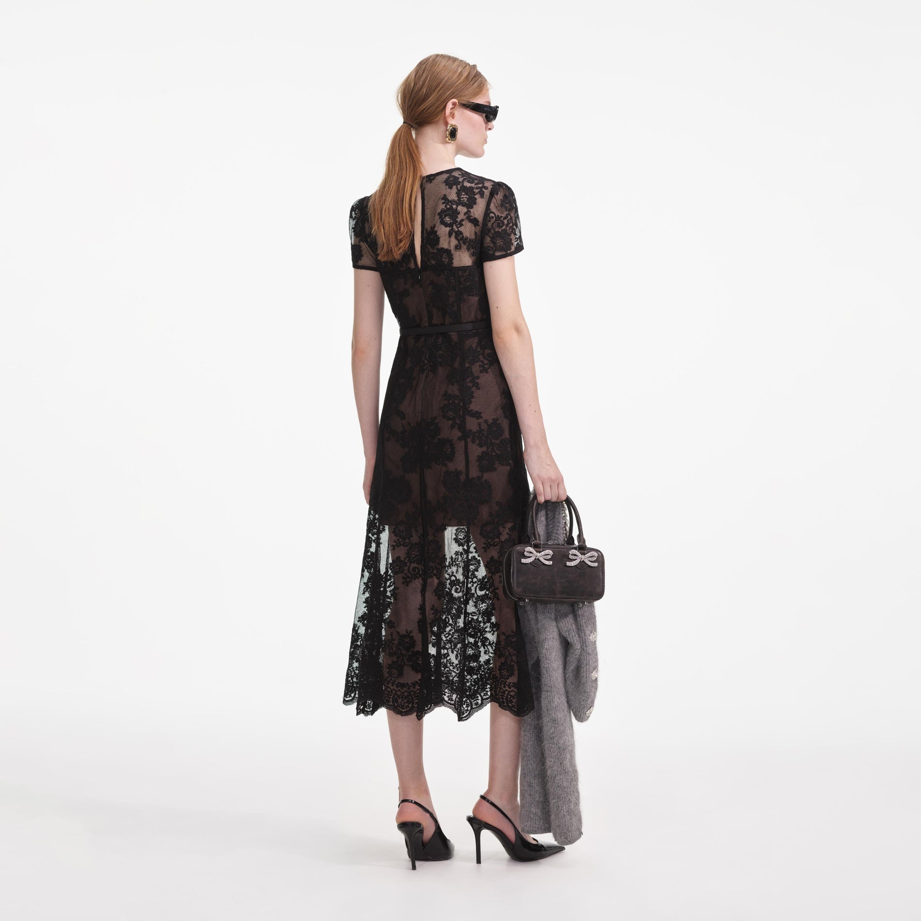 Back view of a woman wearing the Black Lace Bustier Midi Dress