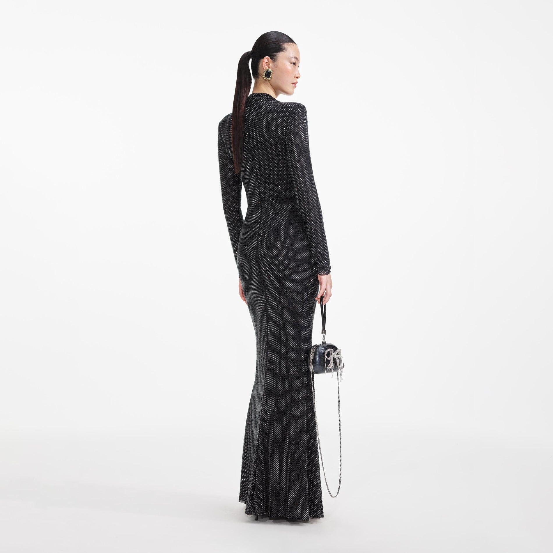 Back view of a woman wearing the Black Rhinestone Mesh Cut Out Maxi Dress