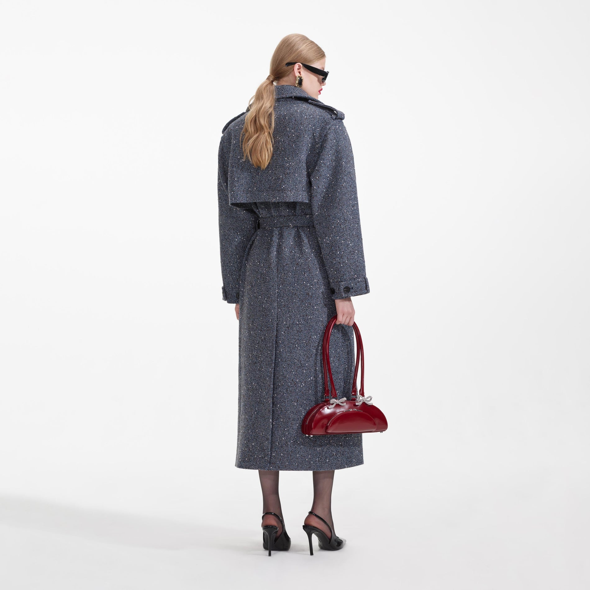 Back view of a woman wearing the Blue Boucle Trench Coat