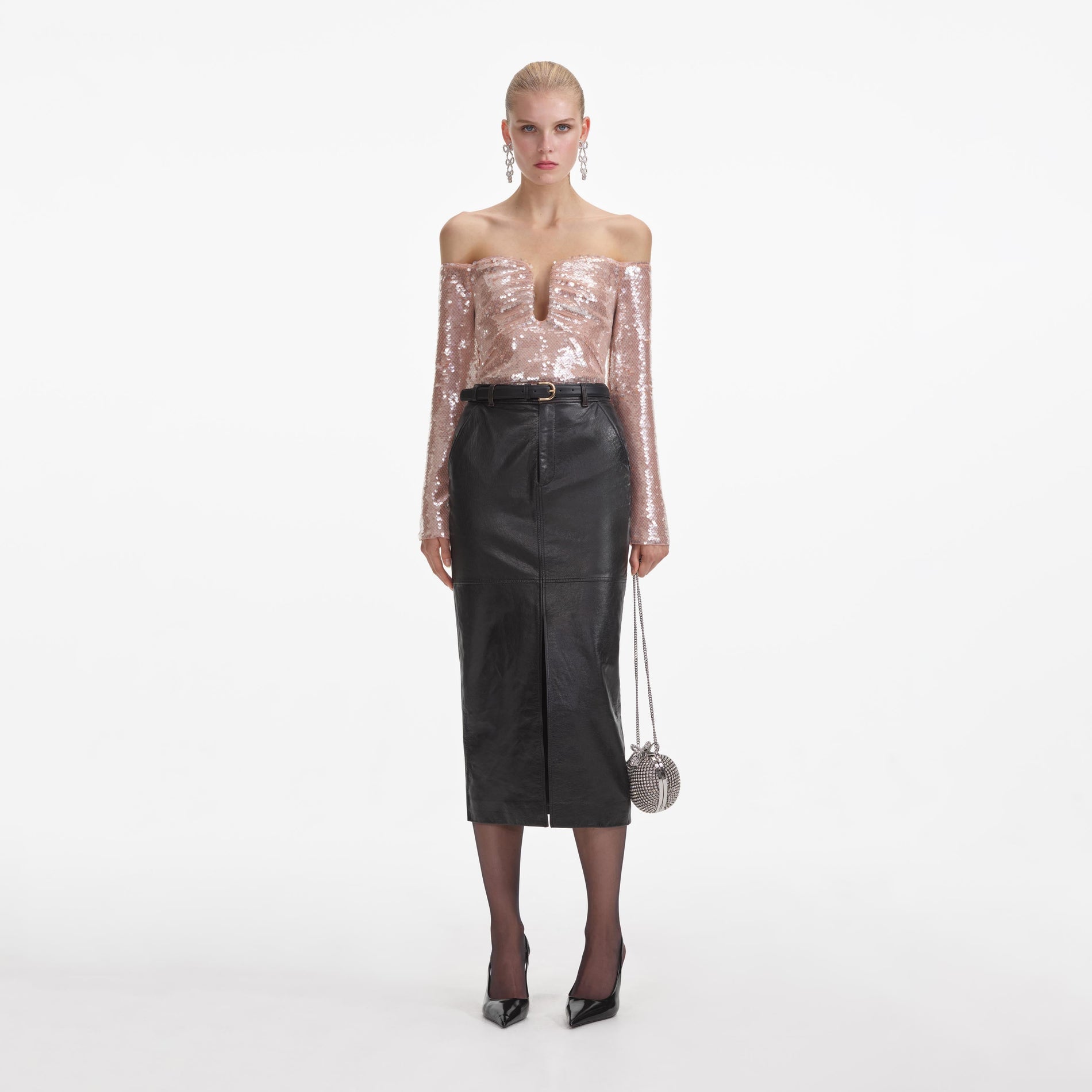 Front view of a woman wearing the Black Leather Midi Skirt