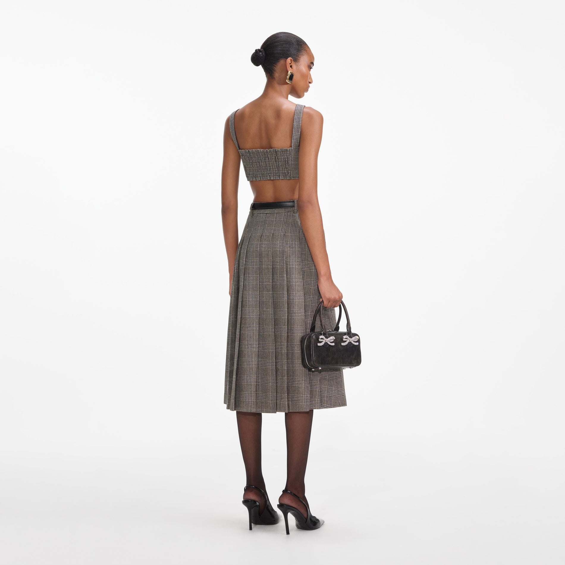 Back view of a woman wearing the Brown Check Pleated Midi Skirt