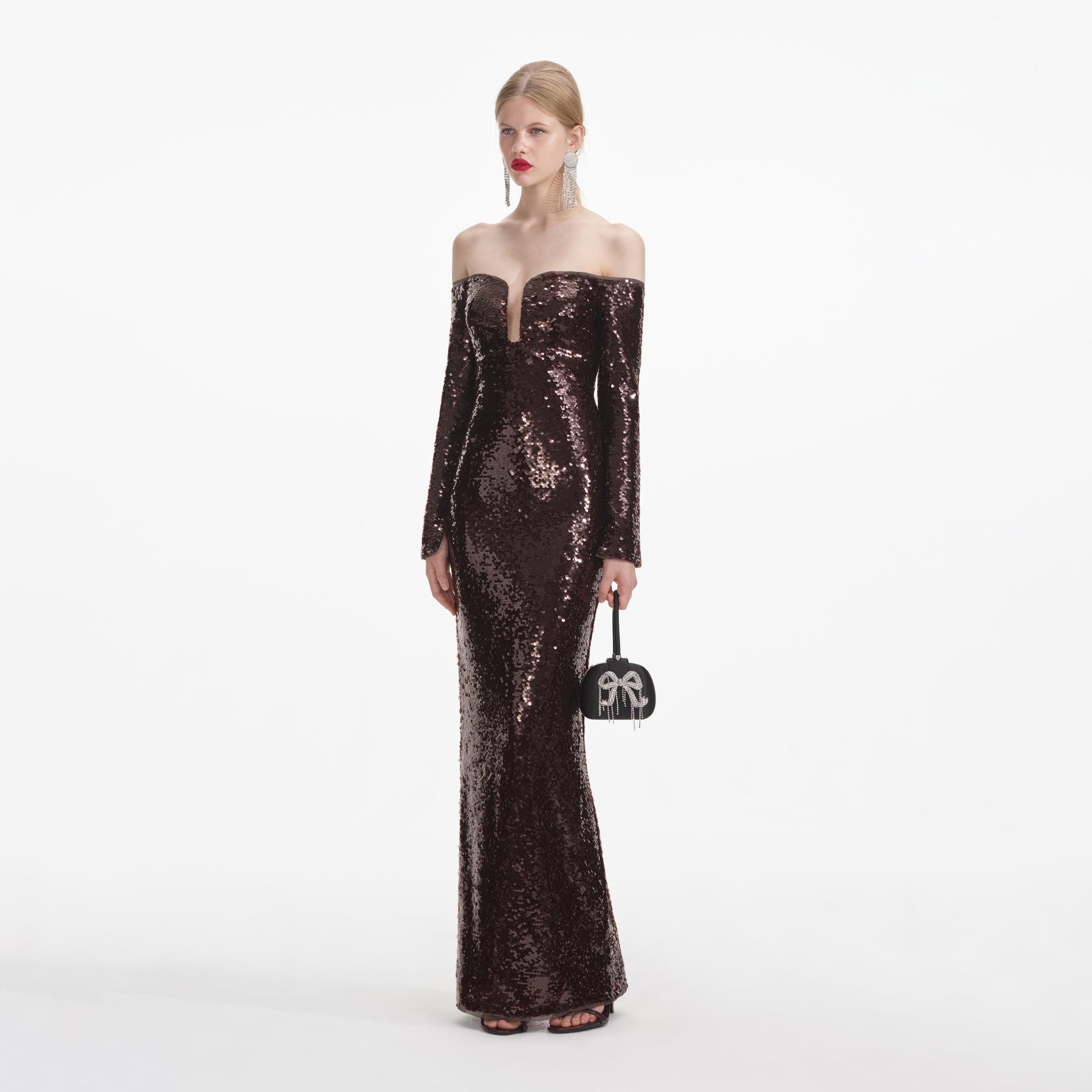 Side view of a woman wearing the Brown Sequin Off Shoulder Maxi Dress