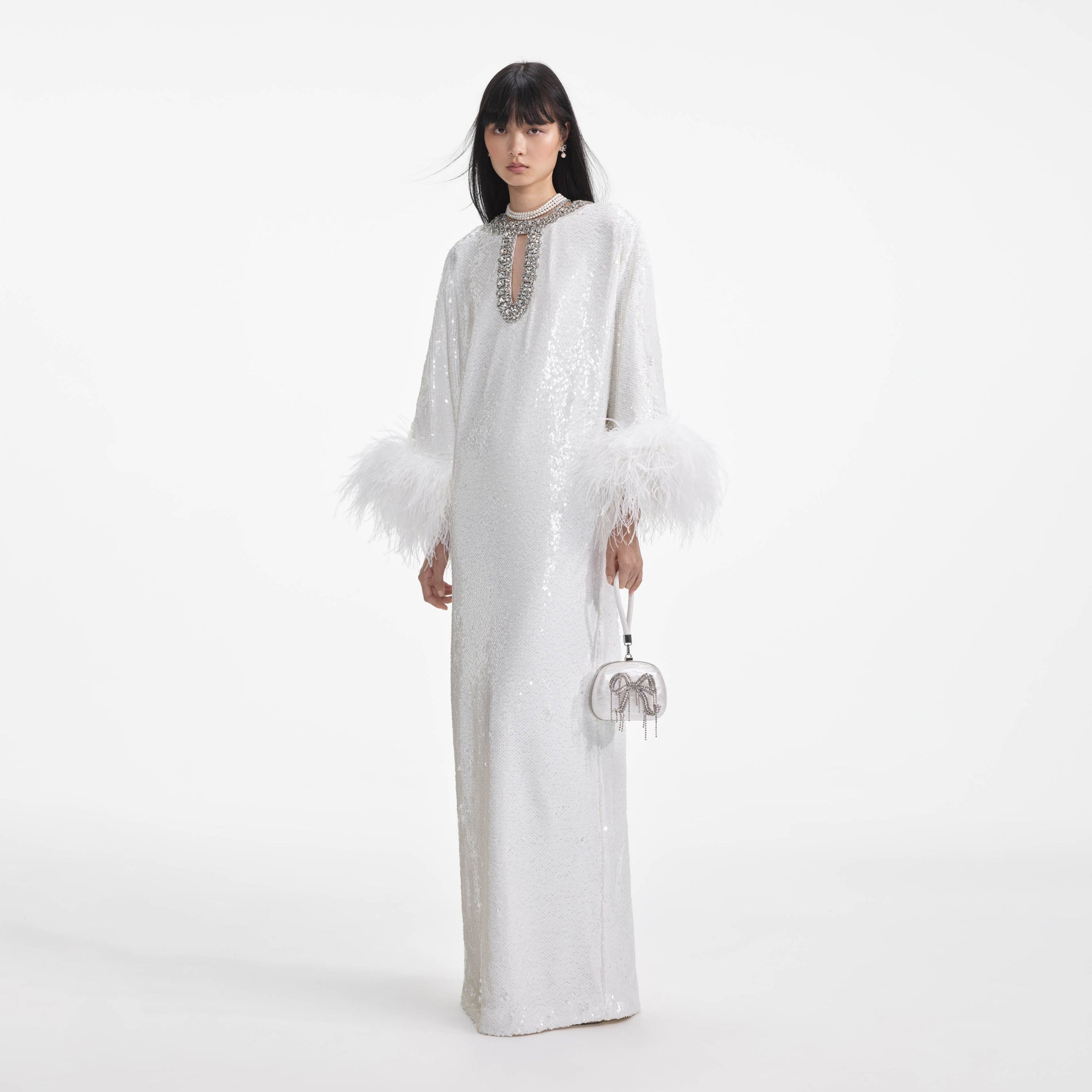 Side view of a woman wearing the White Sequin Feather Maxi Dress