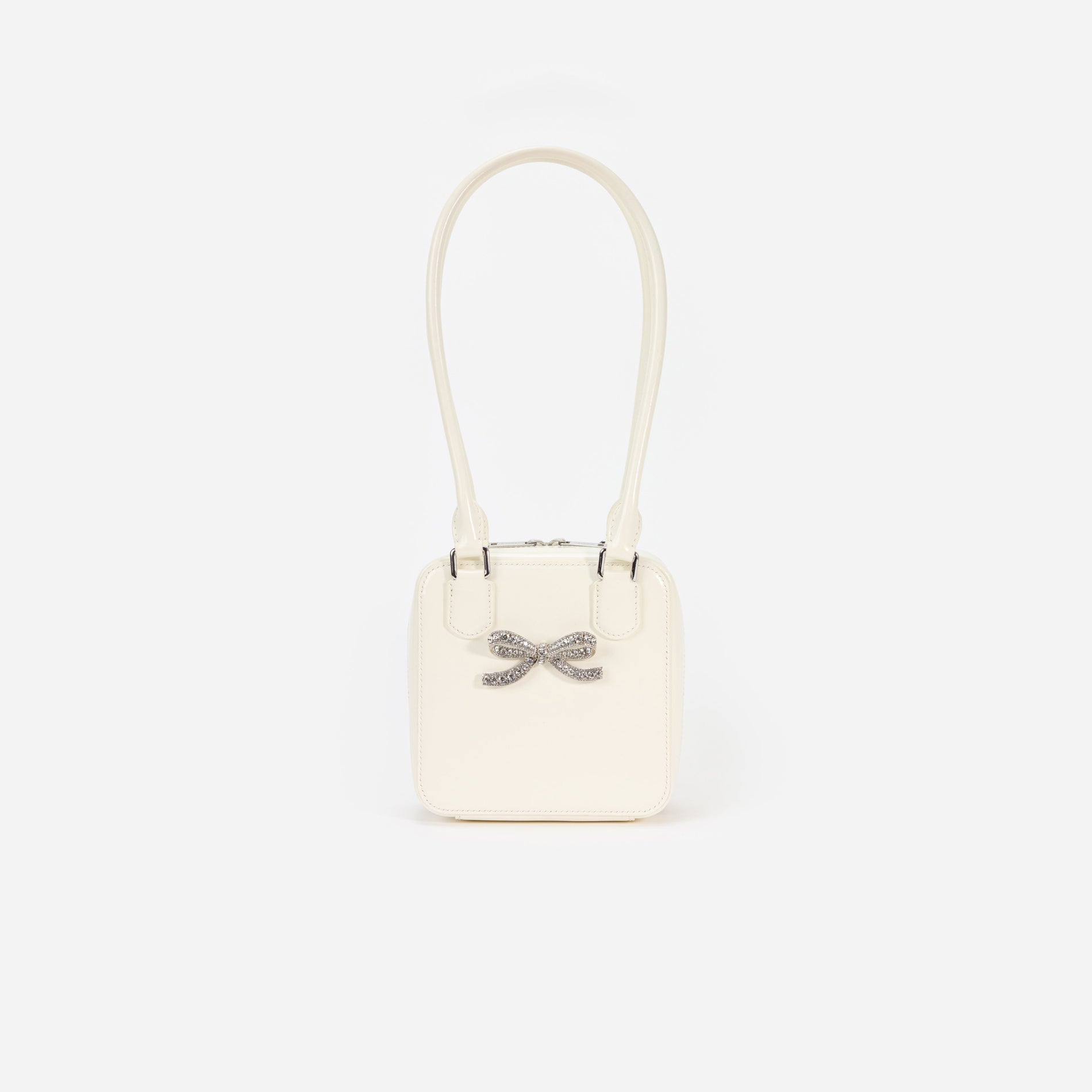 Front view of a woman wearing the Cream Leather Square Shoulder Bag