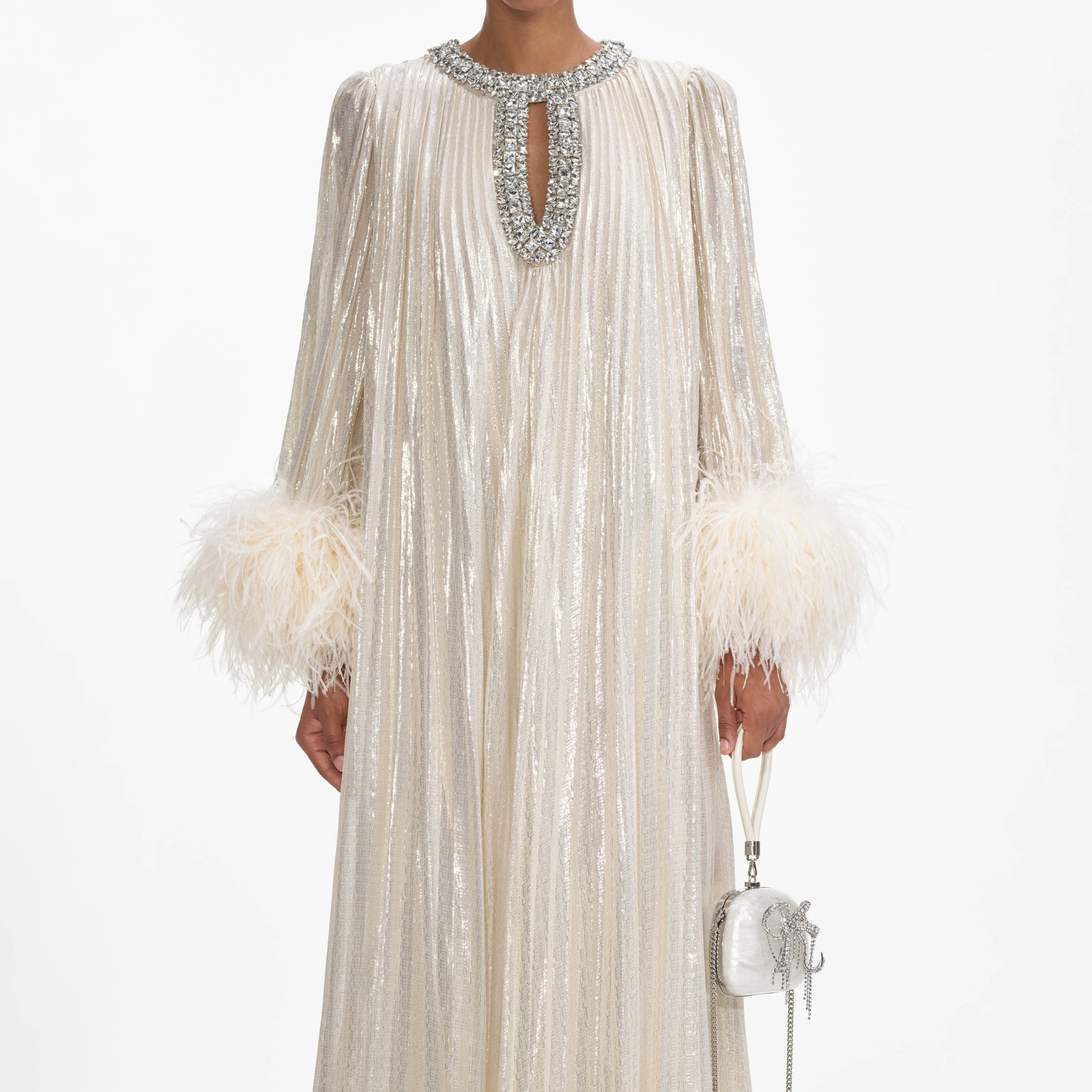 A close up of a woman wearing the Gold Metallic Feather Maxi Dress