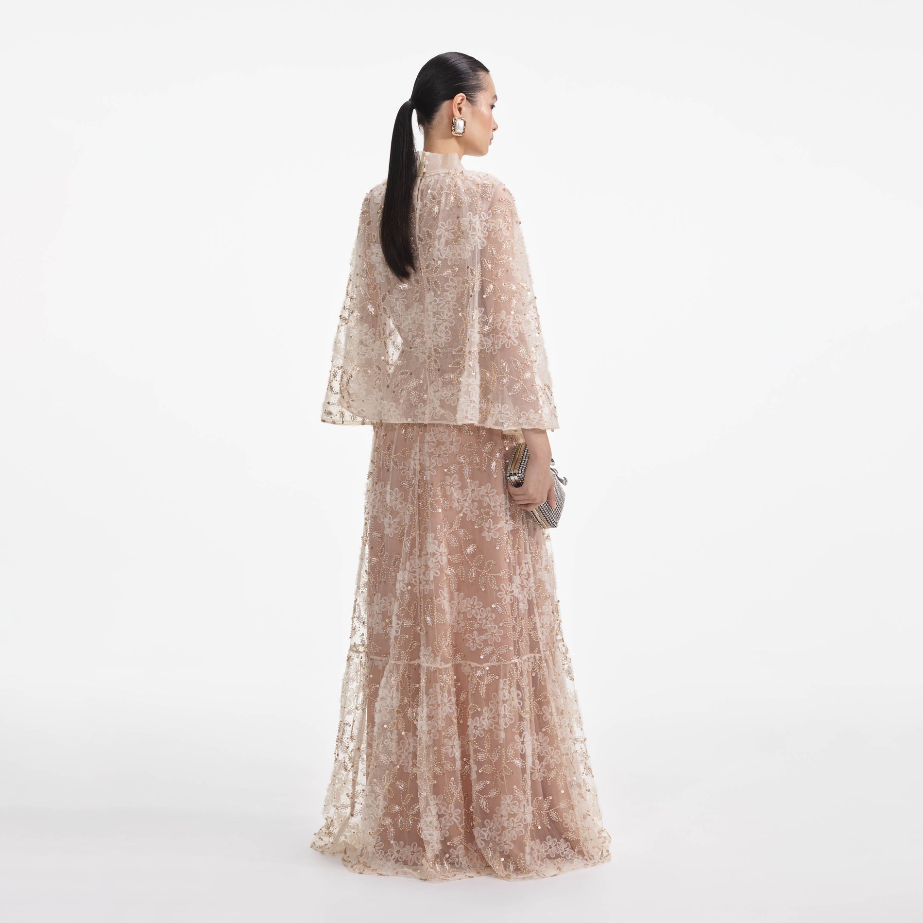 Back view of a woman wearing the Embellished Cape Maxi Dress