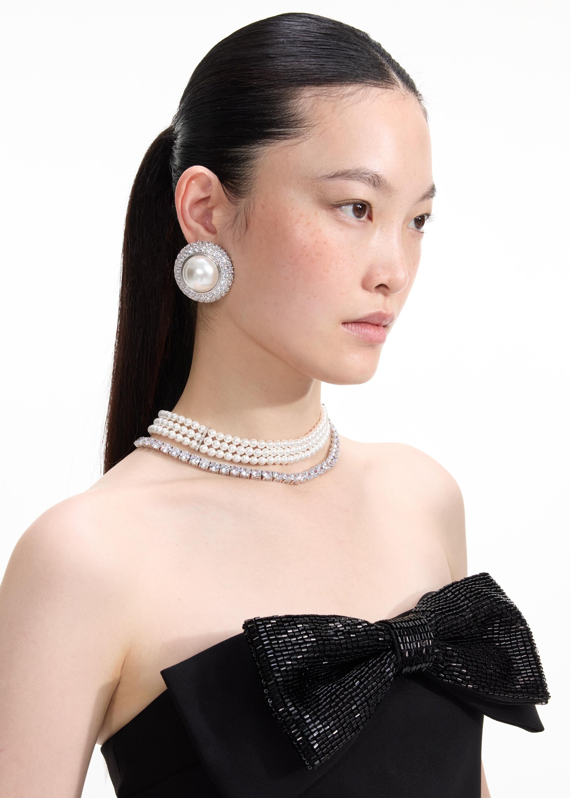 A close up of a woman wearing the Pearl Diamante Necklace