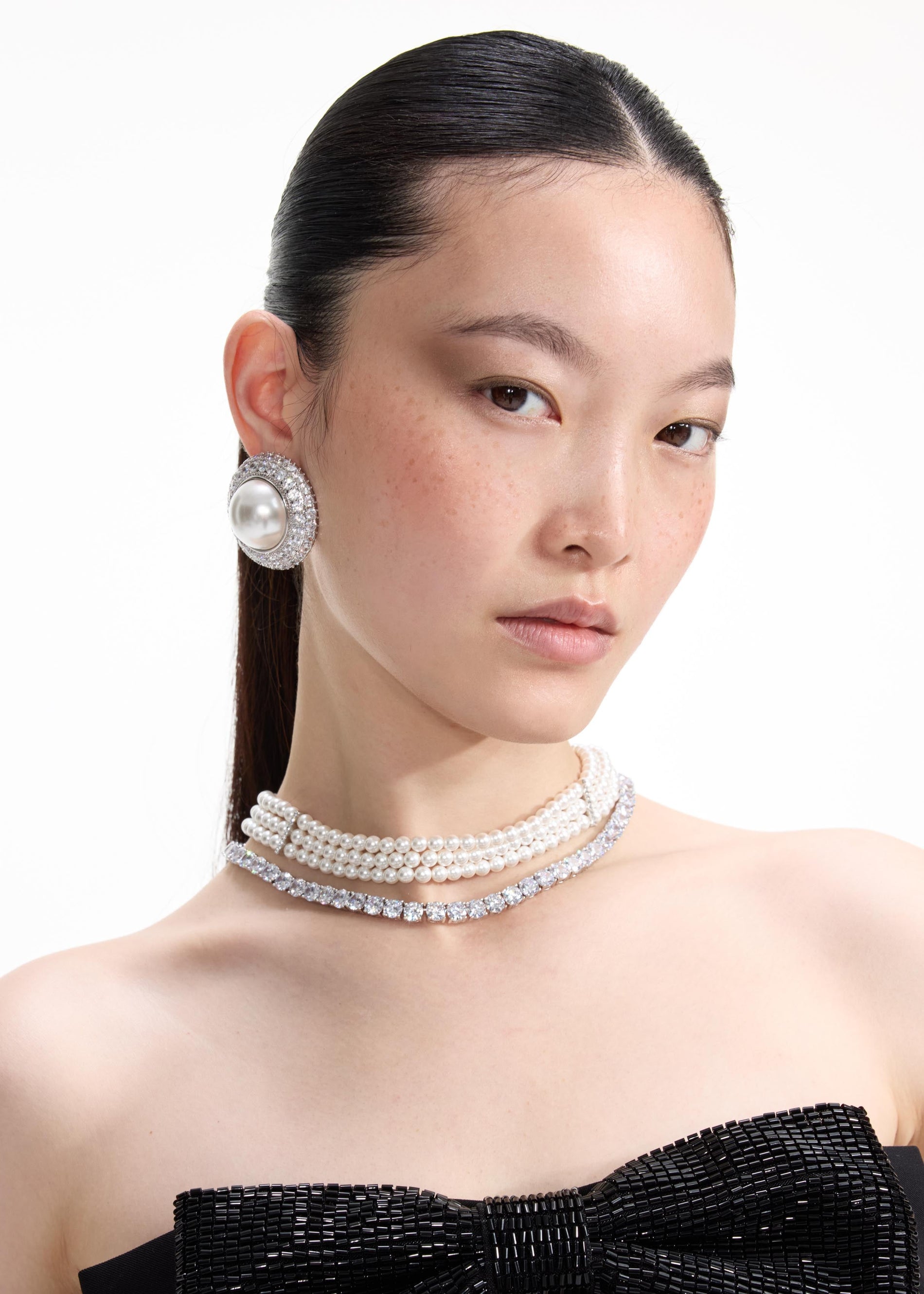 Front view of a woman wearing the Pearl Diamante Necklace