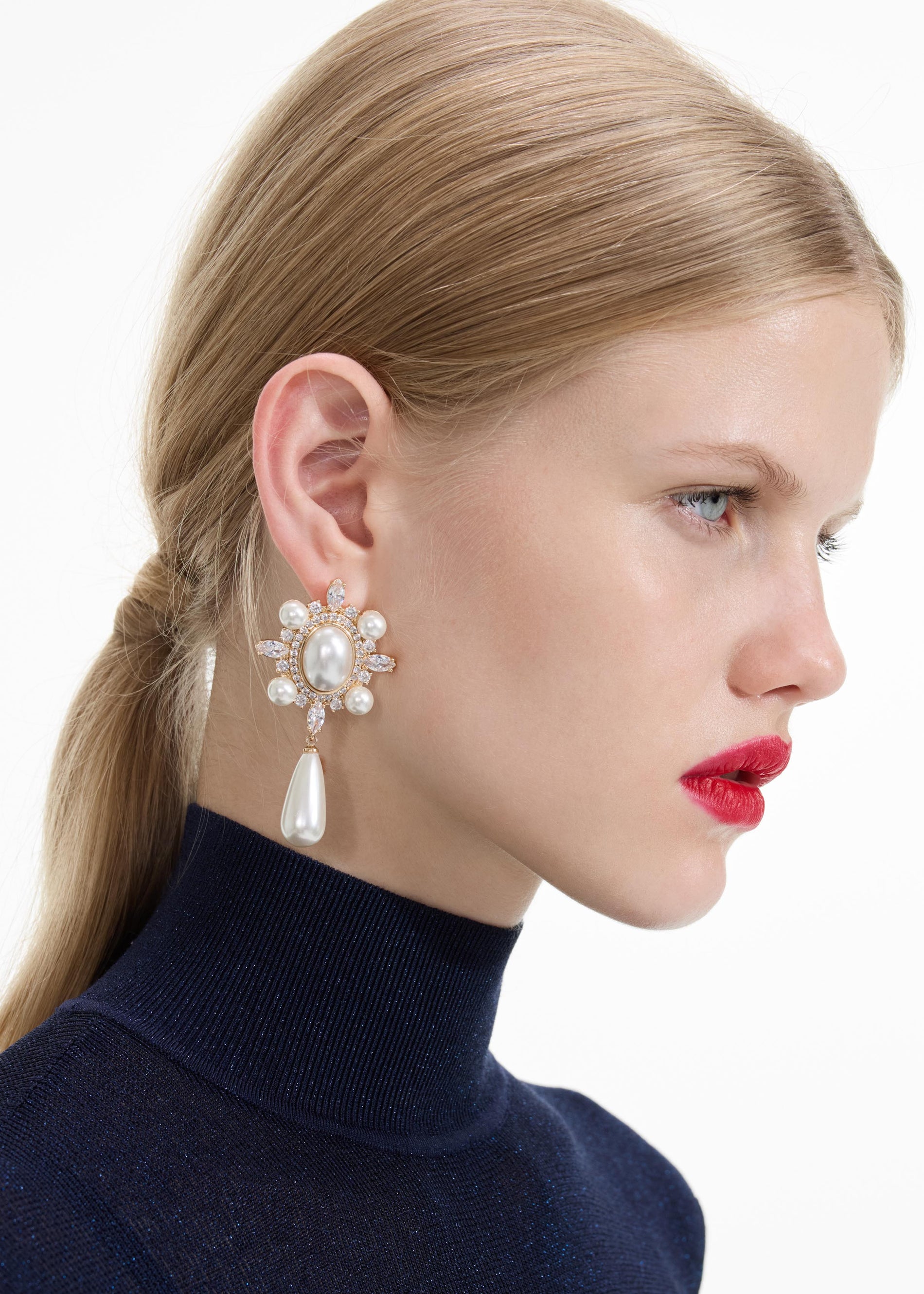 Back view of a woman wearing the Gold Pearl Droplet Earrings