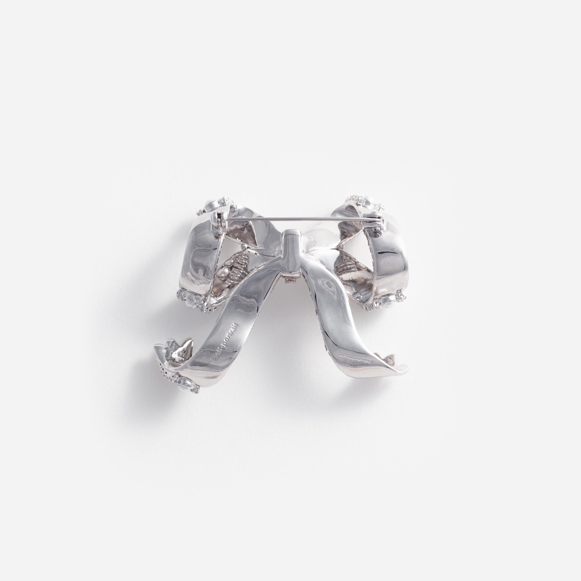 Side view of a woman wearing the Pearl Crystal Bow Brooch