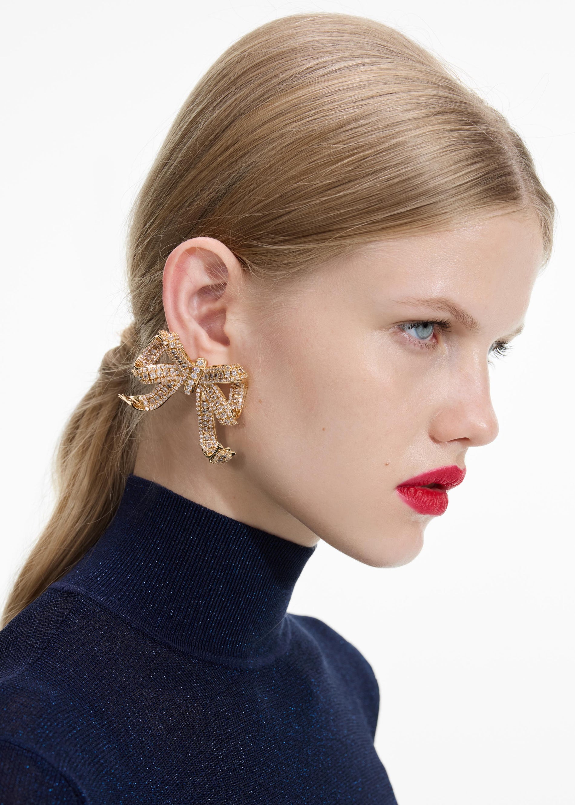 Back view of a woman wearing the Gold Crystal Bow Earrings