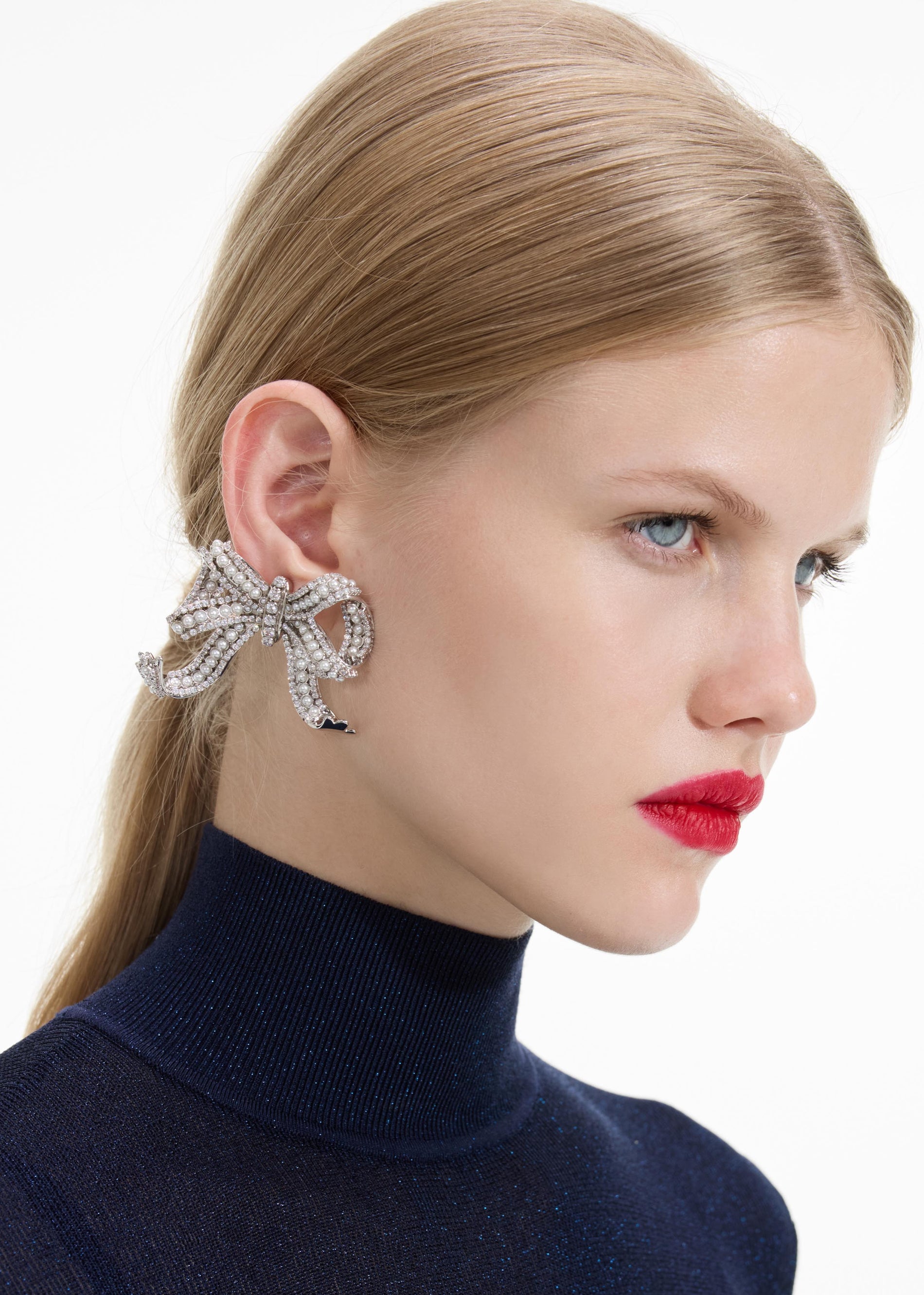 Back view of a woman wearing the Pearl Crystal Bow Earrings