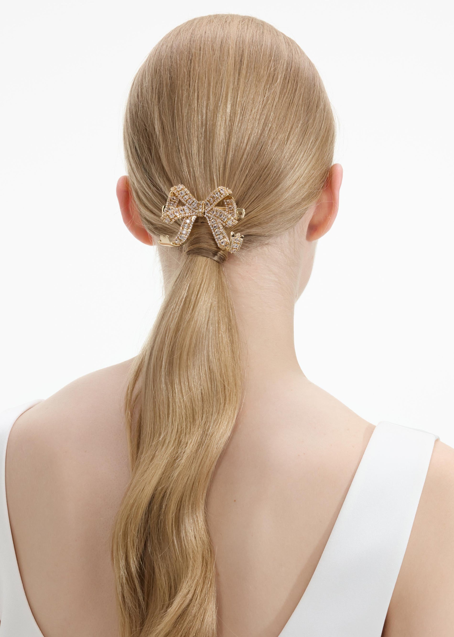 Back view of a woman wearing the Gold Crystal Bow Hair Clip