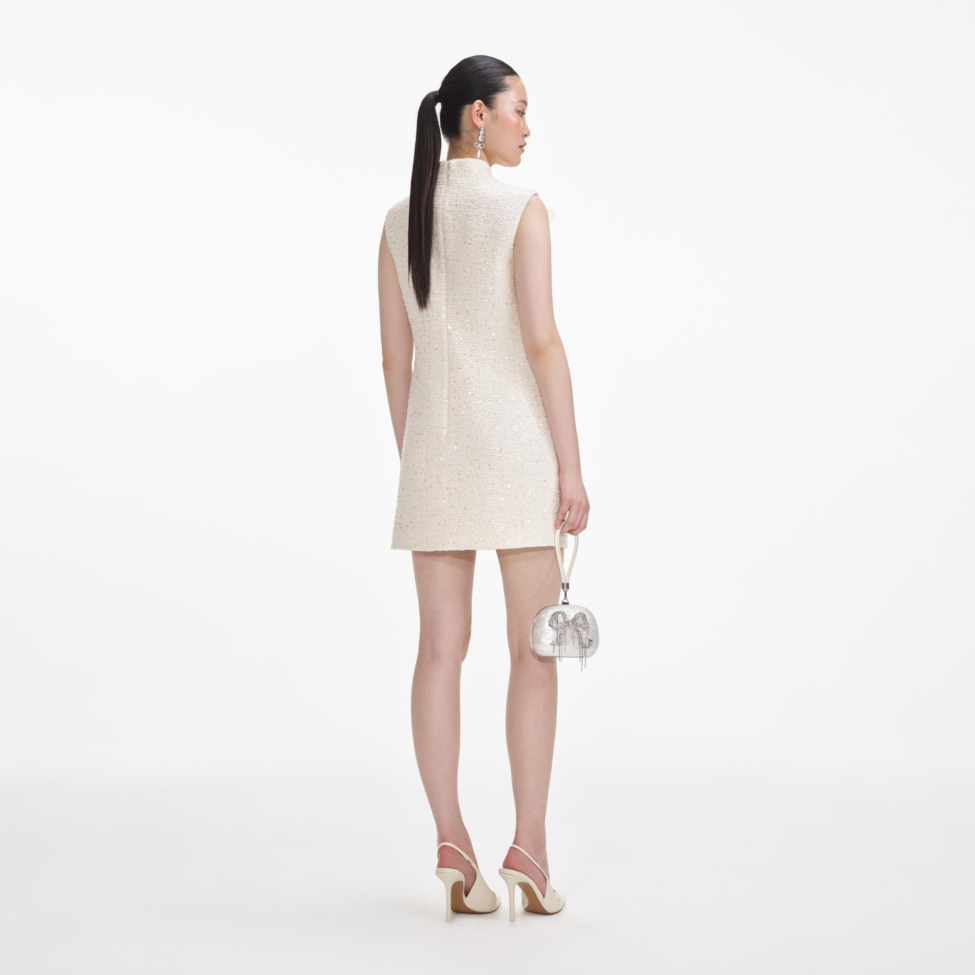 Back view of a woman wearing the Cream Boucle Flower Motif Mini Dress