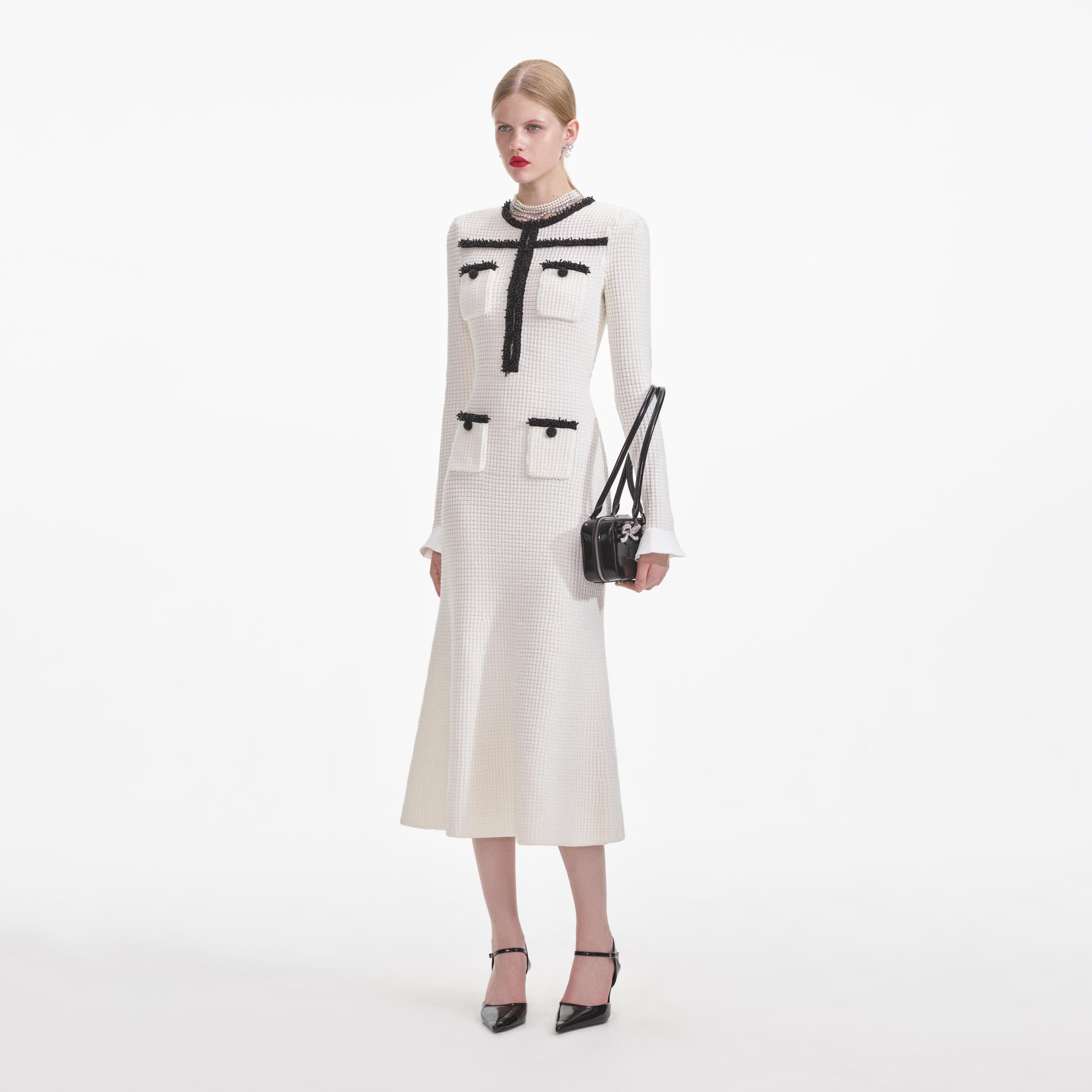 Side view of a woman wearing the White Knit Contrast Trim Midi Dress