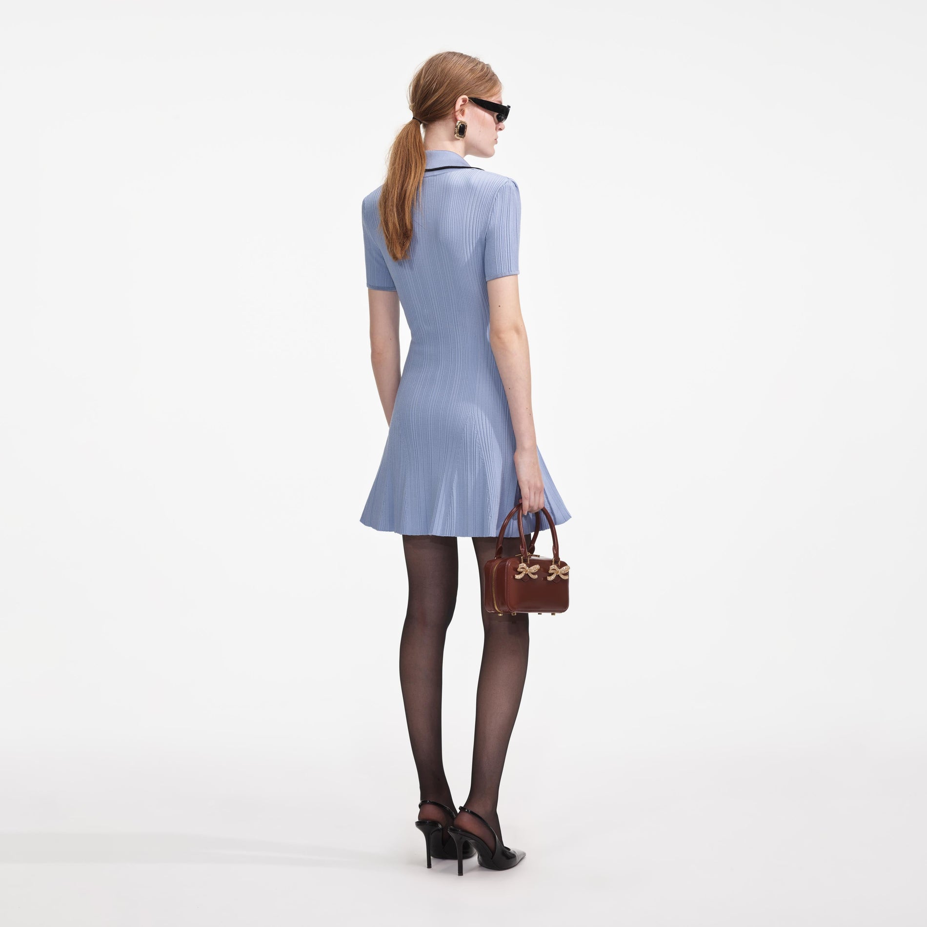 Back view of a woman wearing the Blue Viscose Rib Knit - Mini Dress