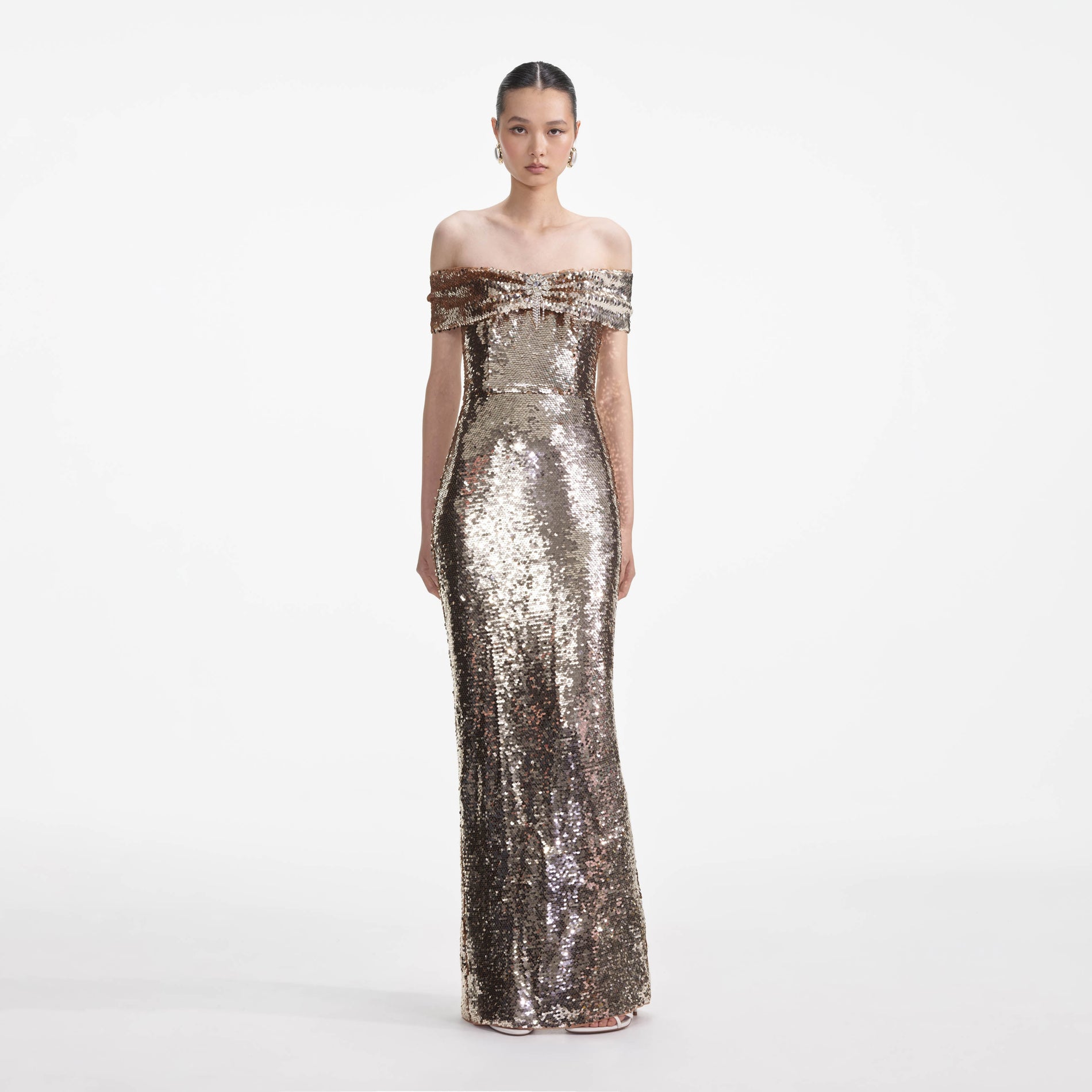 Front view of a woman wearing the Gold Sequin Maxi Dress