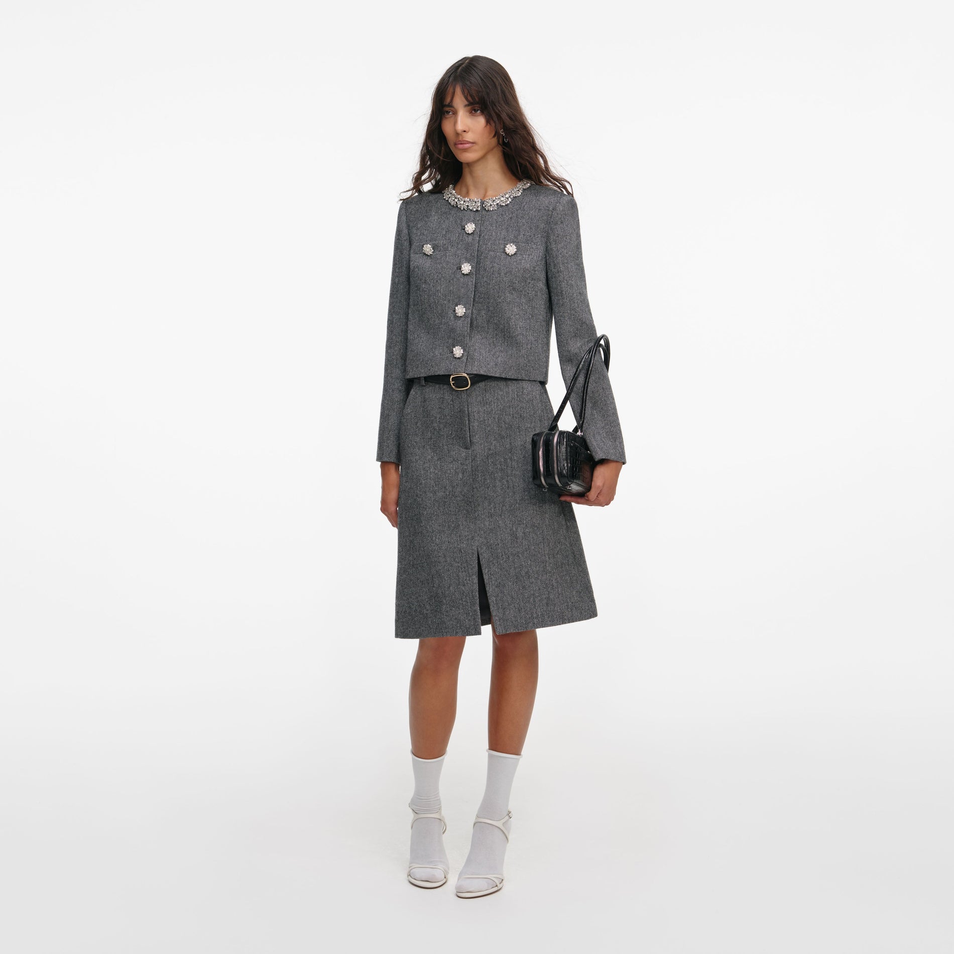 Side view of a woman wearing the Grey Herringbone Crystal Trim Jacket