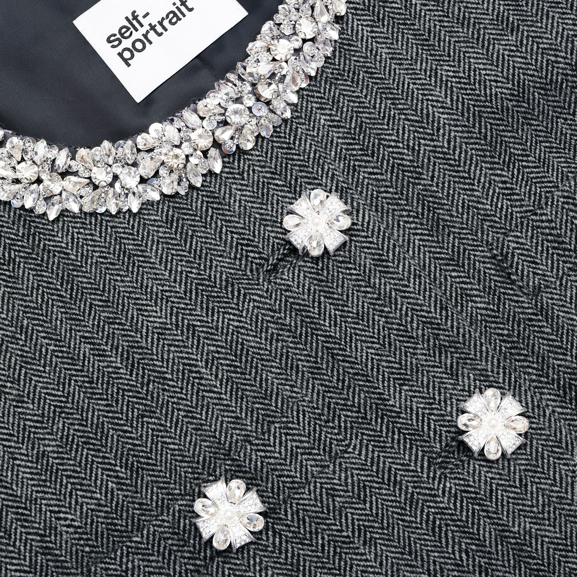 A close up of the fabric for the Grey Herringbone Crystal Trim Jacket