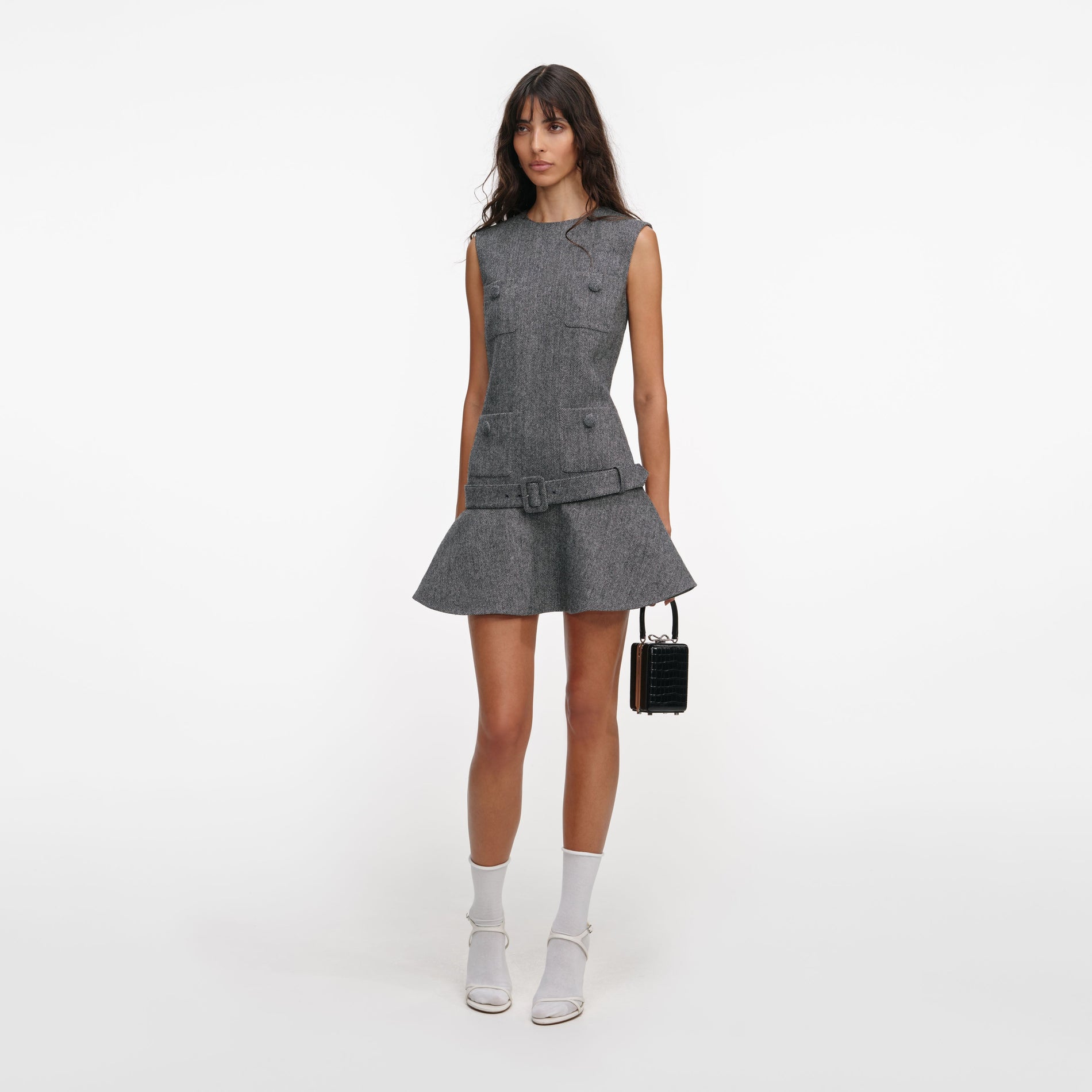 Side view of a woman wearing the Grey Herringbone Flared Mini Dress