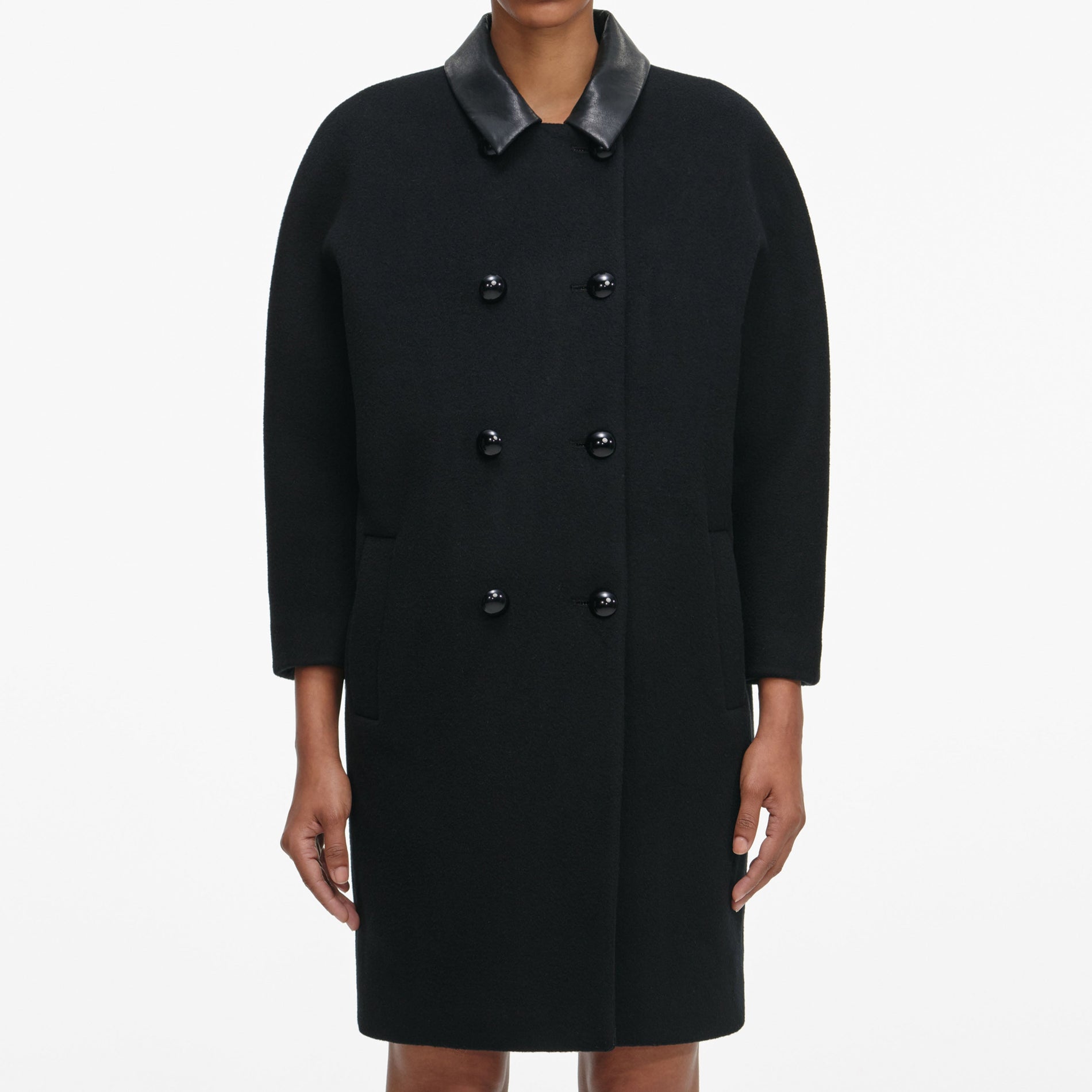 A close up of a woman wearing the Black Double Breasted Coat