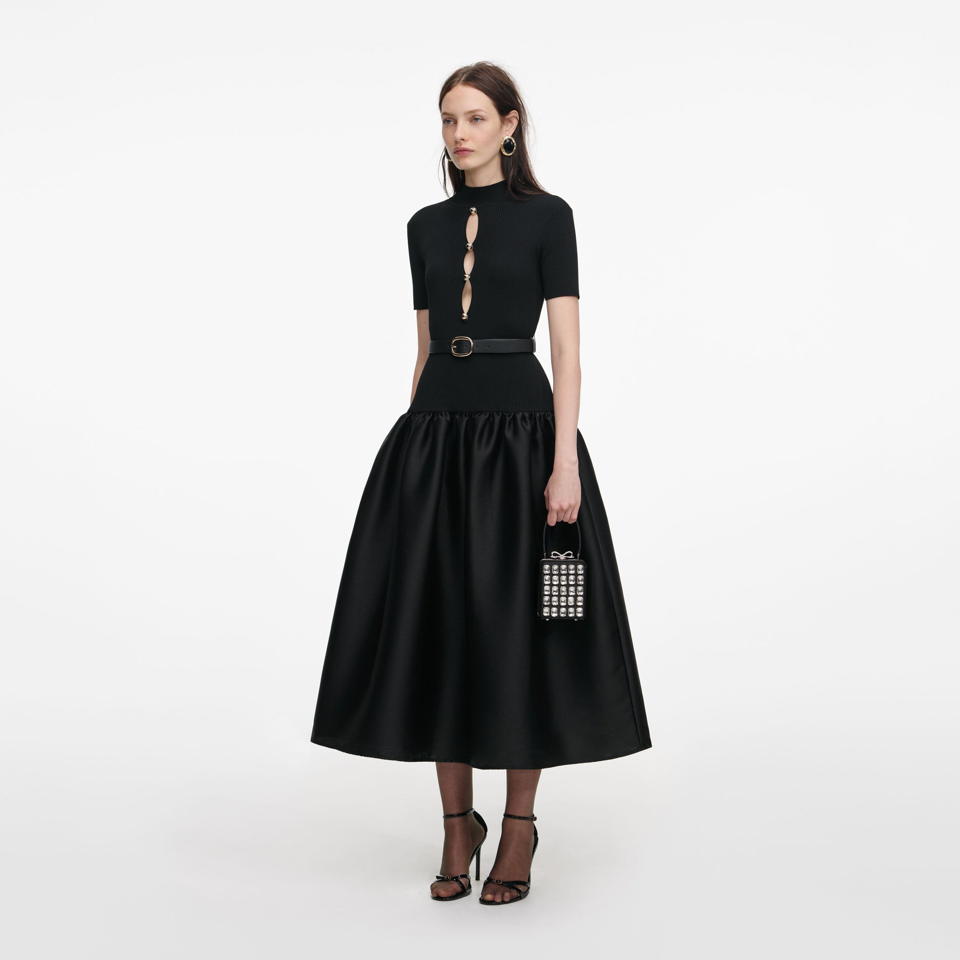 Side view of a woman wearing the Black Knit Taffeta Midi Dress