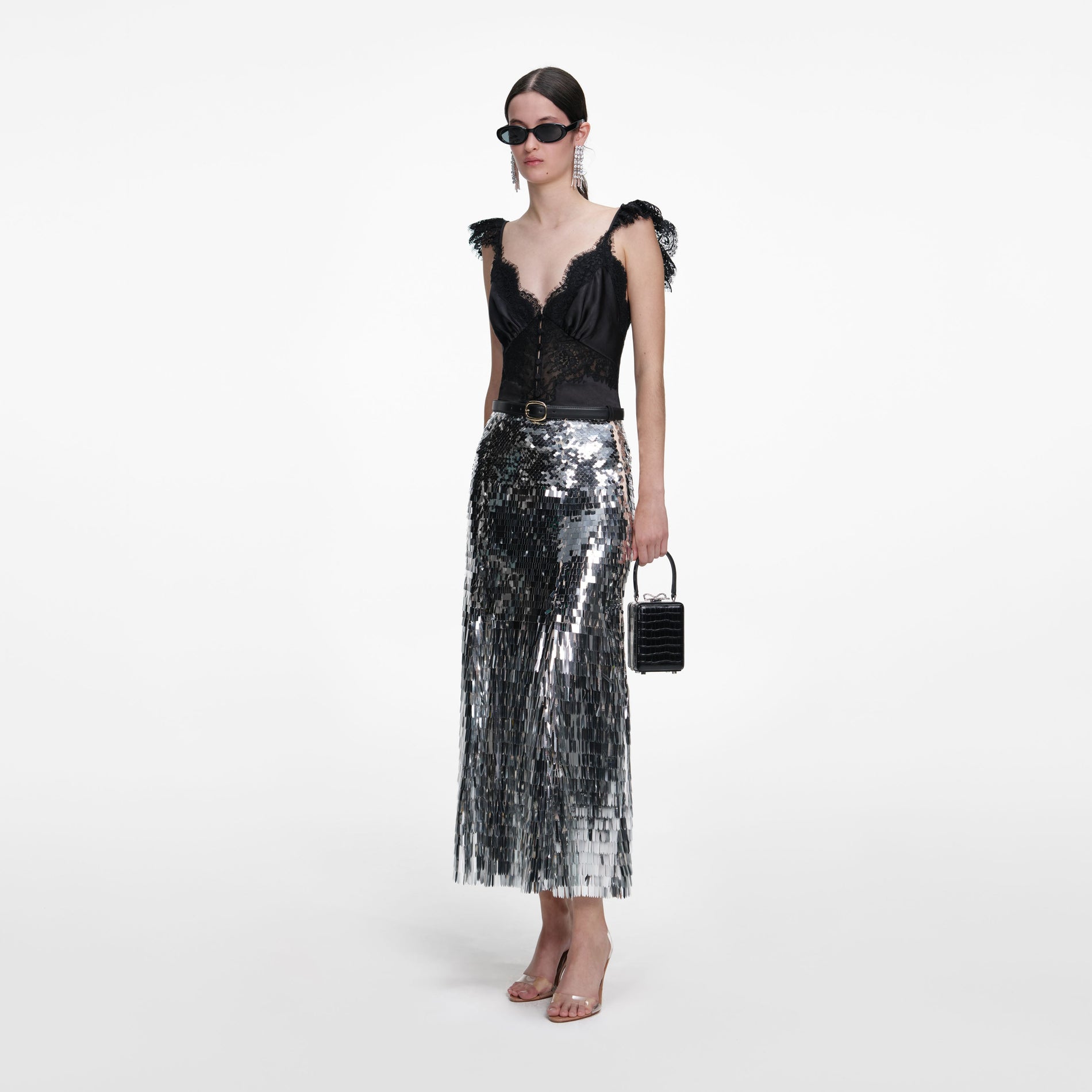 Side view of a woman wearing the Silver Gradient Sequin Midi Skirt