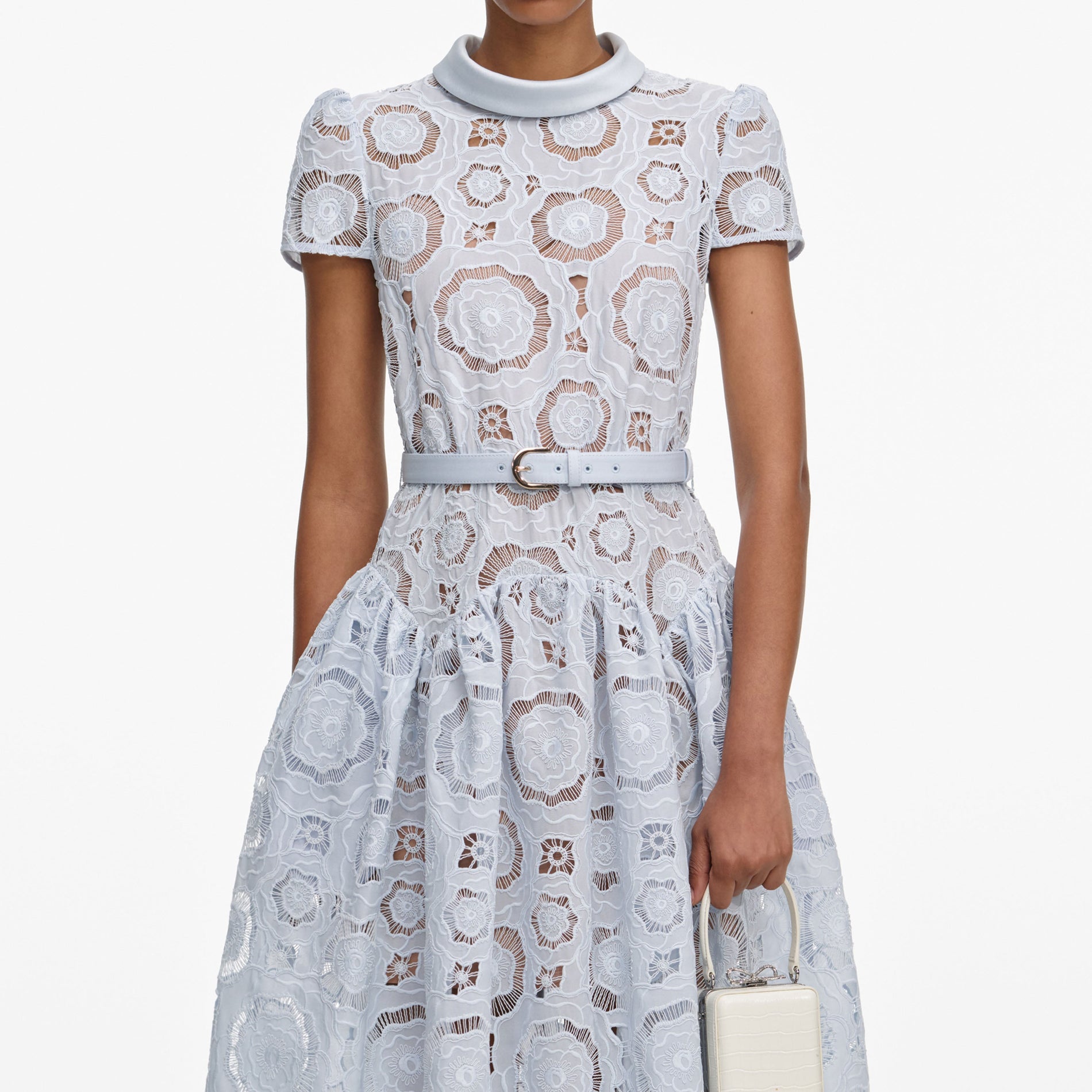 A close up of a woman wearing the Blue Floral Lace  Midi Dress