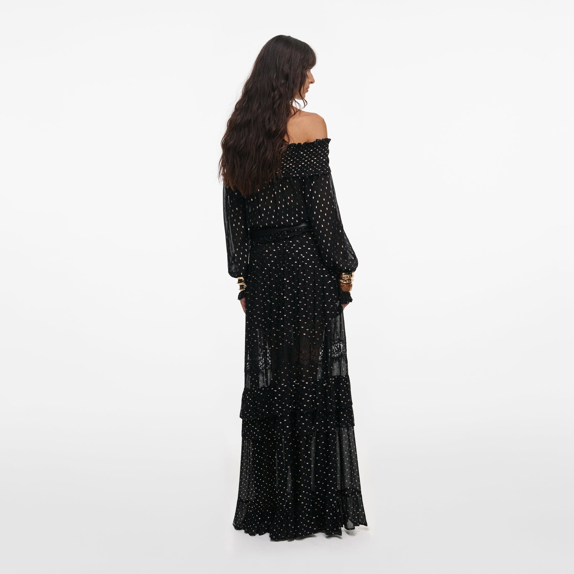 Back view of a woman wearing the Black And Gold Chiffon Lace Maxi Skirt