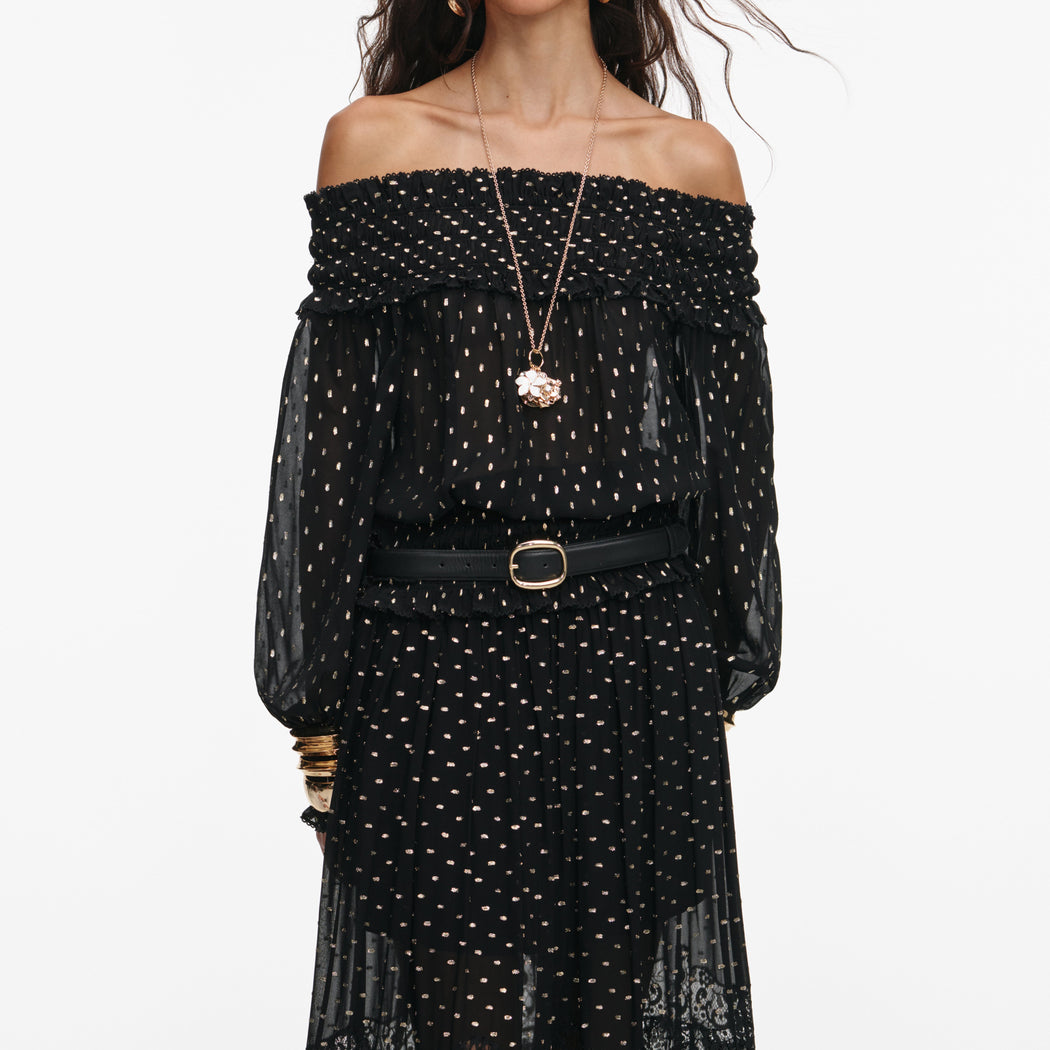 A close up of a woman wearing the Black And Gold Chiffon Lace Maxi Skirt