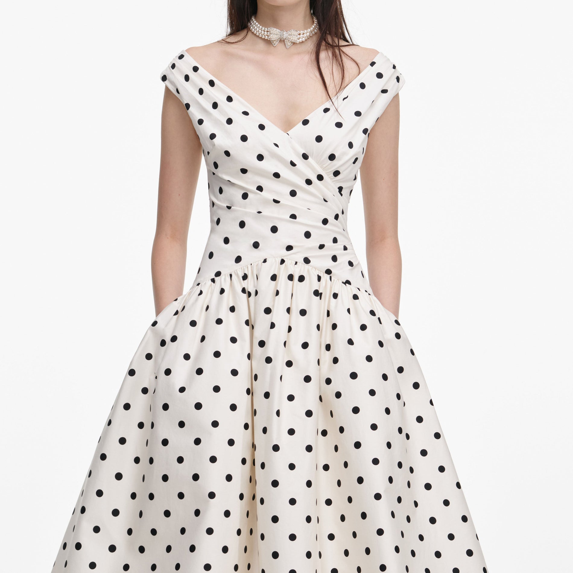 A close up of a woman wearing the Cream Polka Dot Cotton Midi Dress
