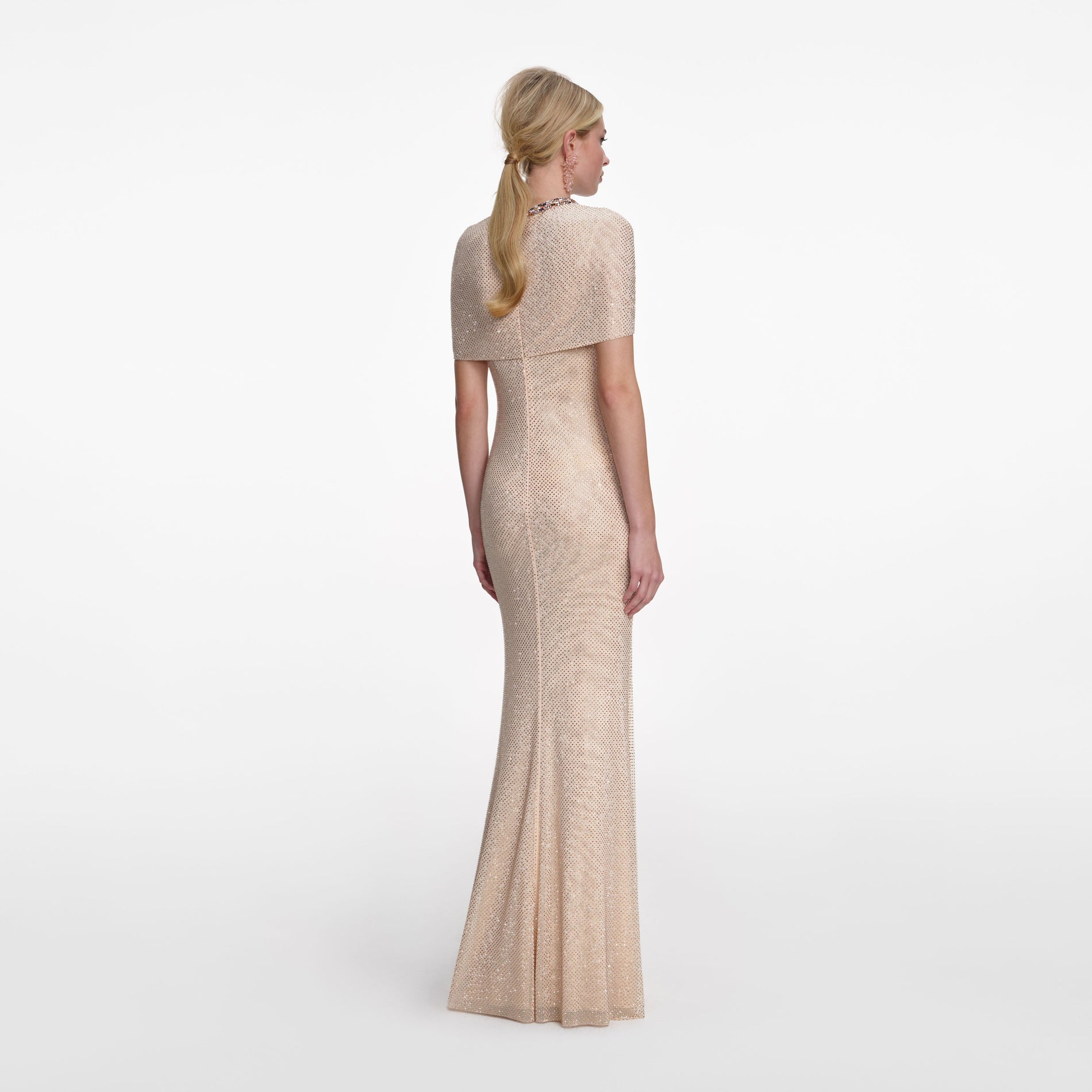 Back view of a woman wearing the Champagne Rhinestone Maxi Dress