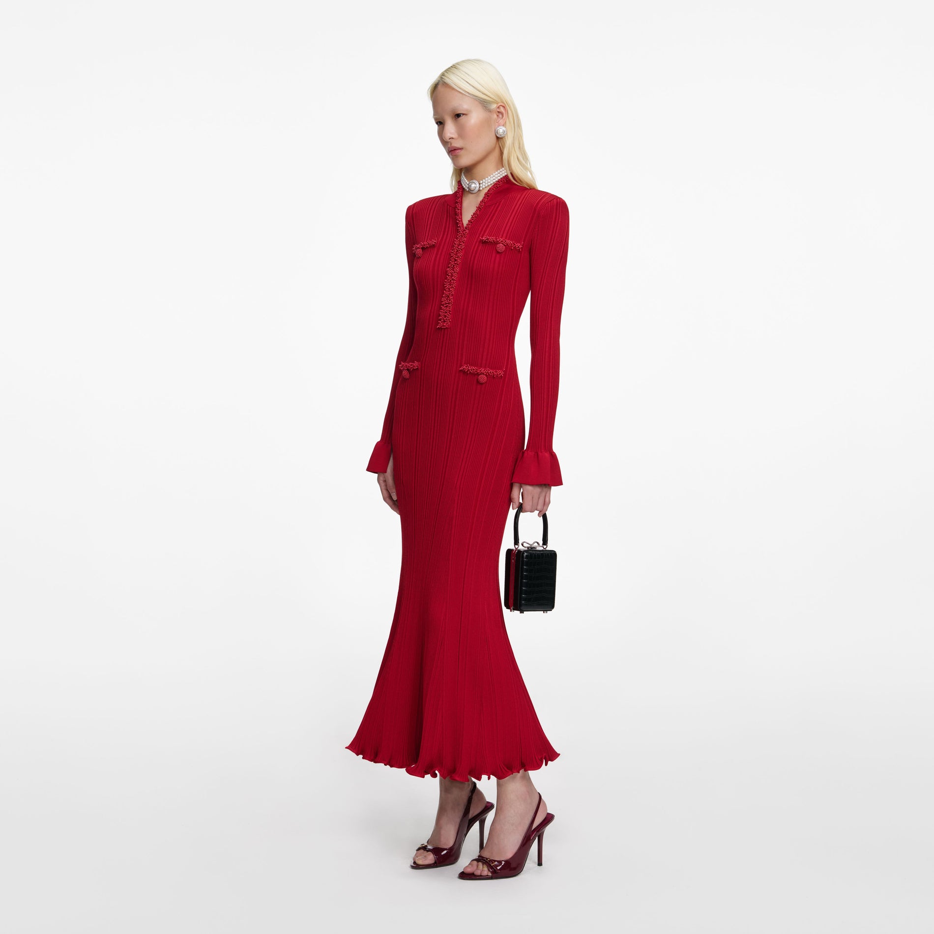 Side view of a woman wearing the Red Pearl Trim Knit Midi Dress