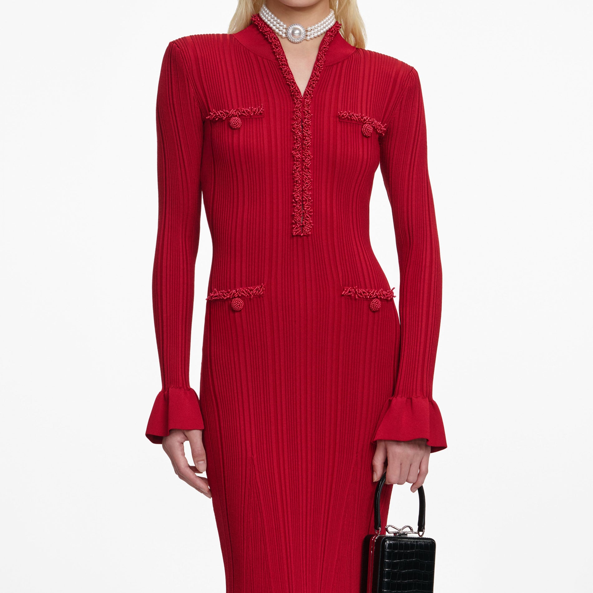 A close up of a woman wearing the Red Pearl Trim Knit Midi Dress