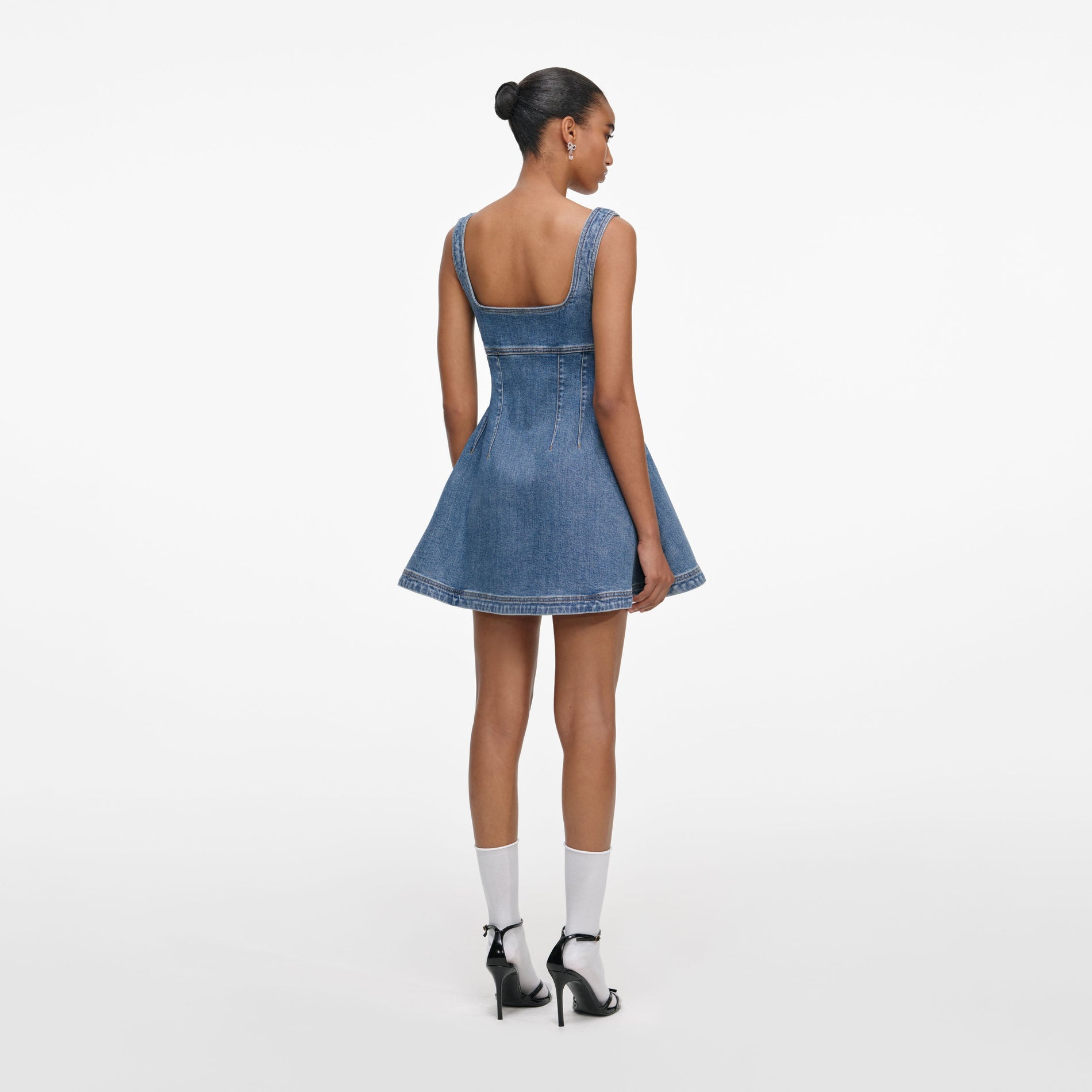 Back view of a woman wearing the Denim Mini Dress
