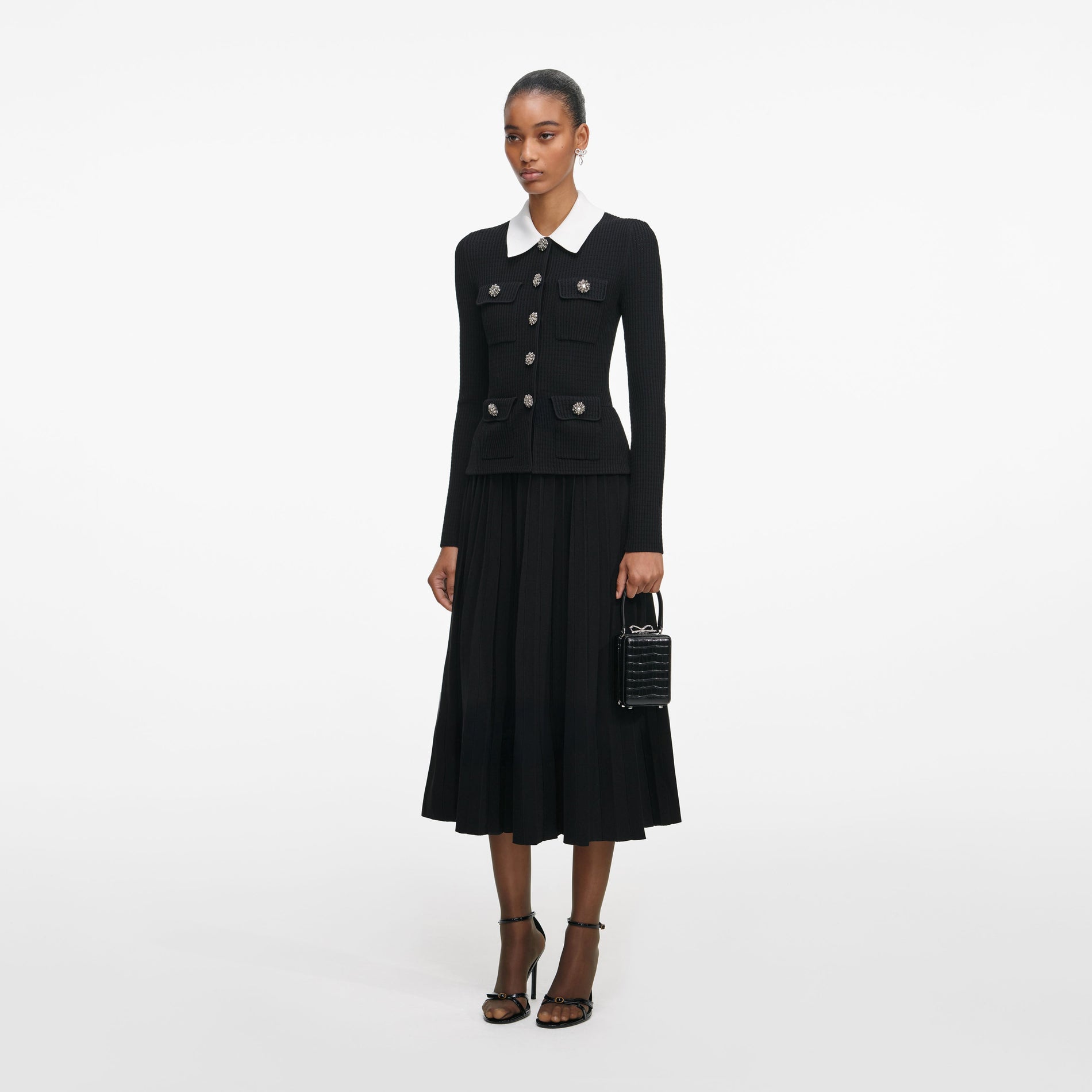 Side view of a woman wearing the Black Tailored Knit Midi Dress