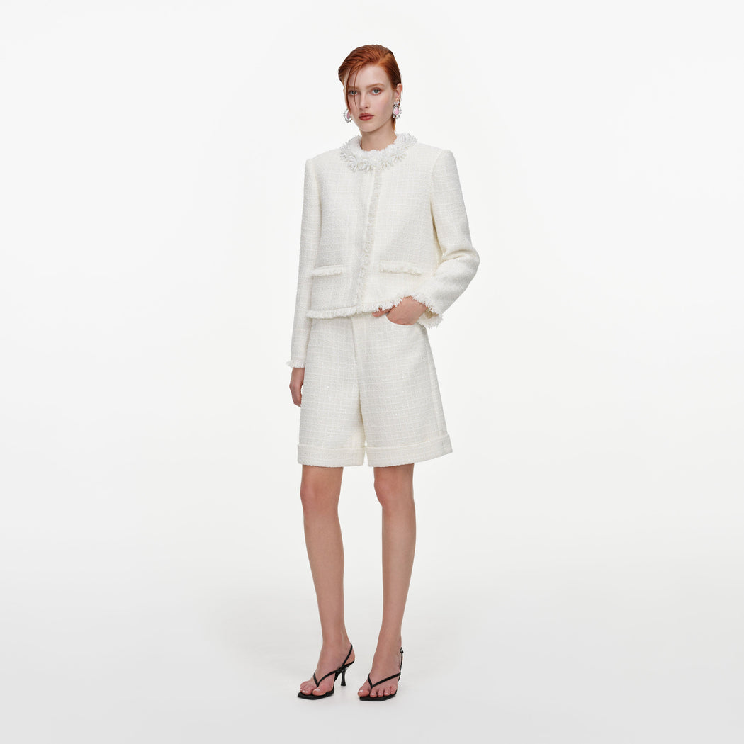 Side view of a woman wearing the Cream Sequin Boucle Pearl Trim Jacket