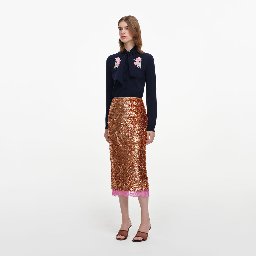 Side view of a woman wearing the Gold Sequin Midi Skirt