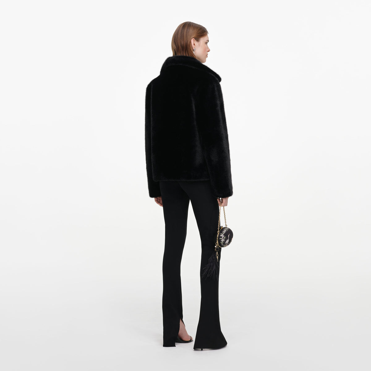 Back view of a woman wearing the Black Faux Fur Jacket