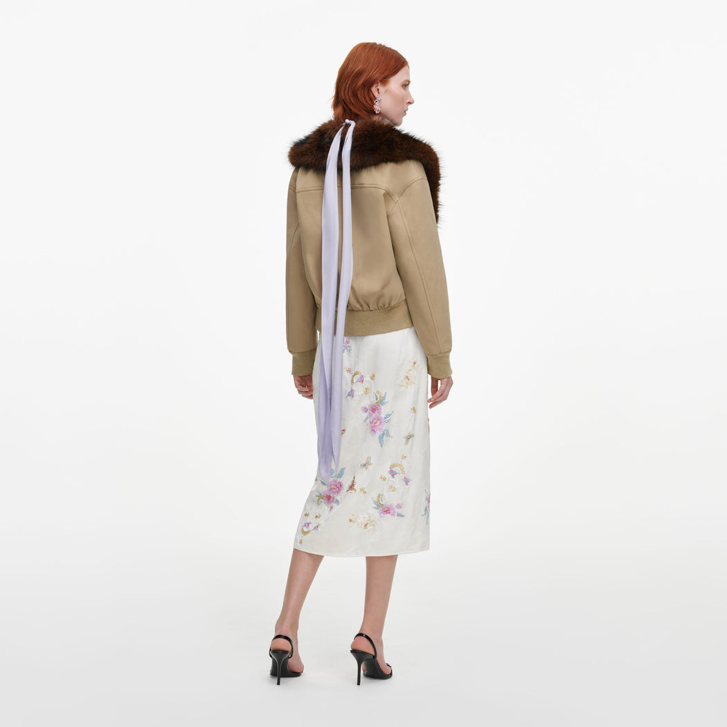 Back view of a woman wearing the Cream Jacquard Floral Midi Skirt