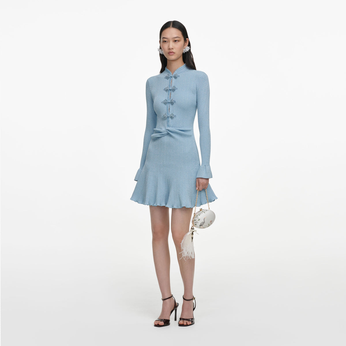 Side view of a woman wearing the Blue Metallic Knit Mini Dress