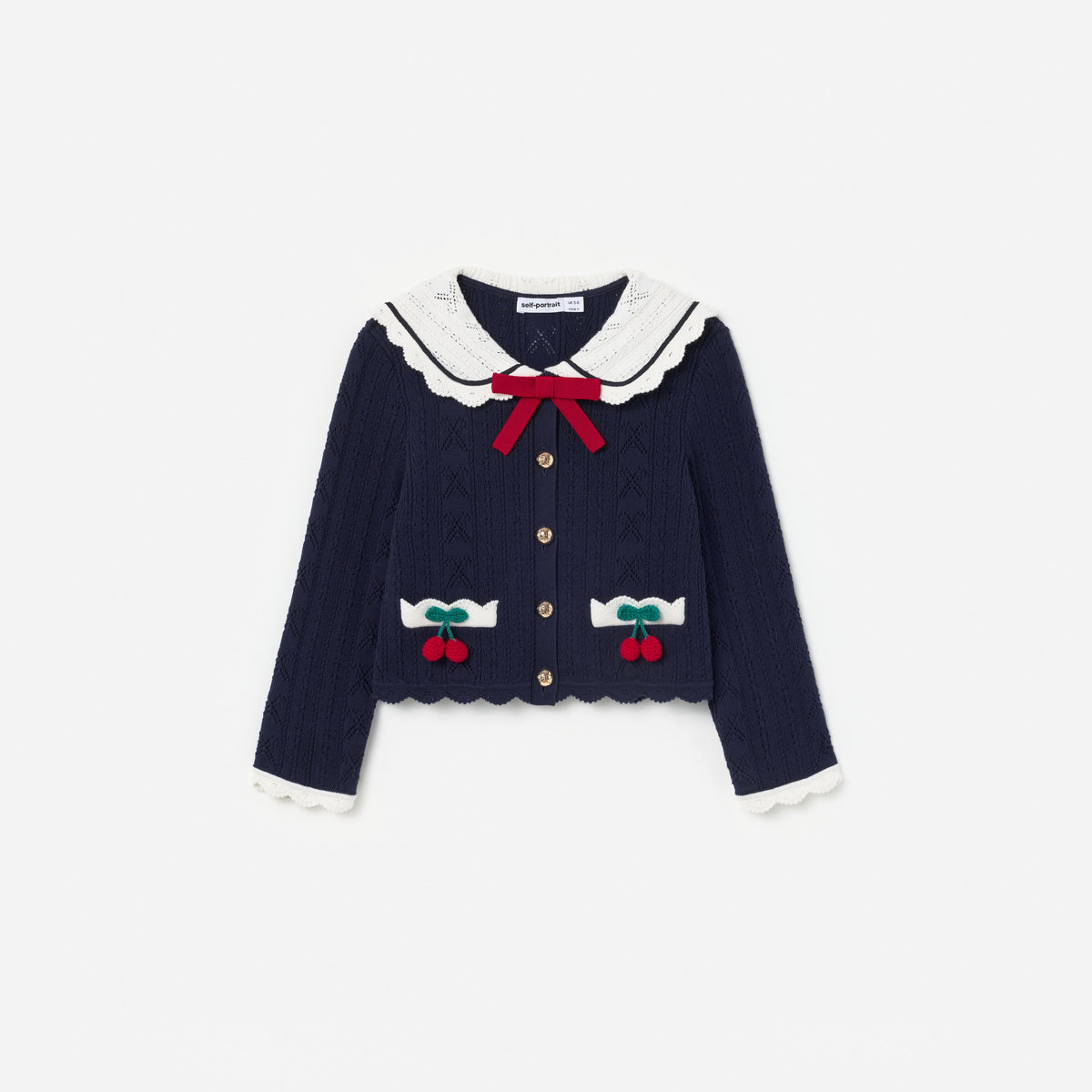Front view of a girl wearing the Navy Pointelle Knit Cherry Cardigan