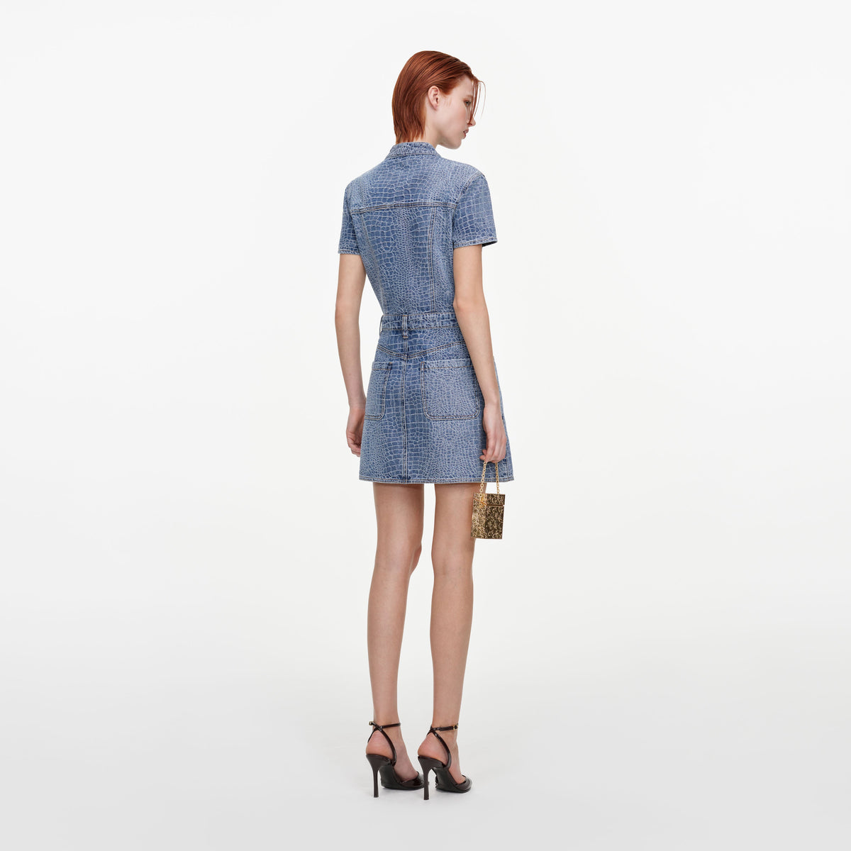 Back view of a woman wearing the Croc Denim Tie Neck Mini Dress