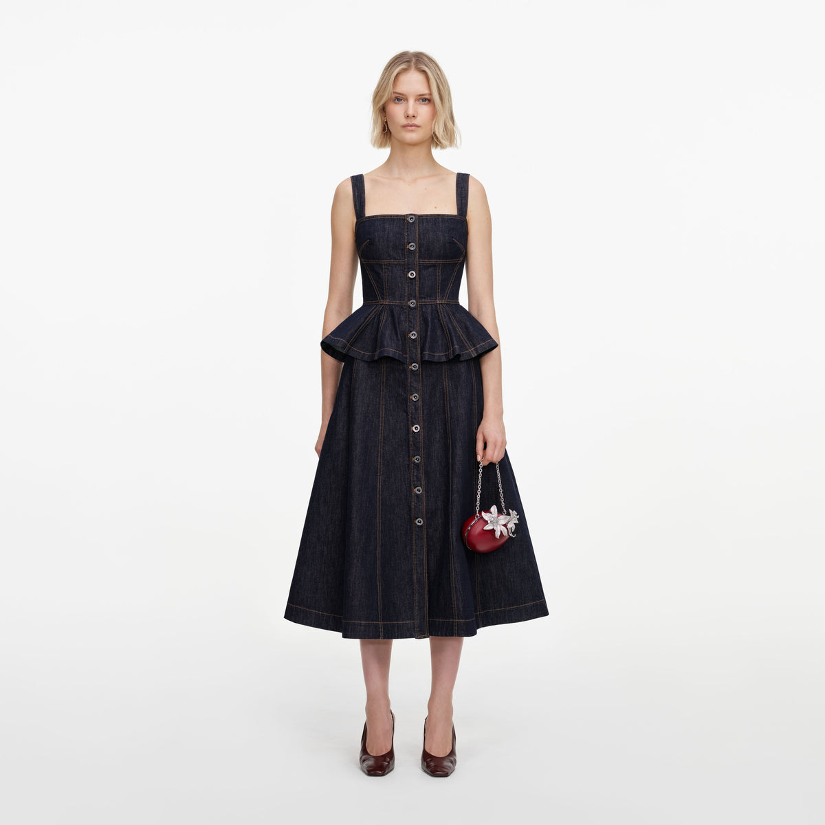Front view of a woman wearing the Indigo Peplum Denim Midi Dress