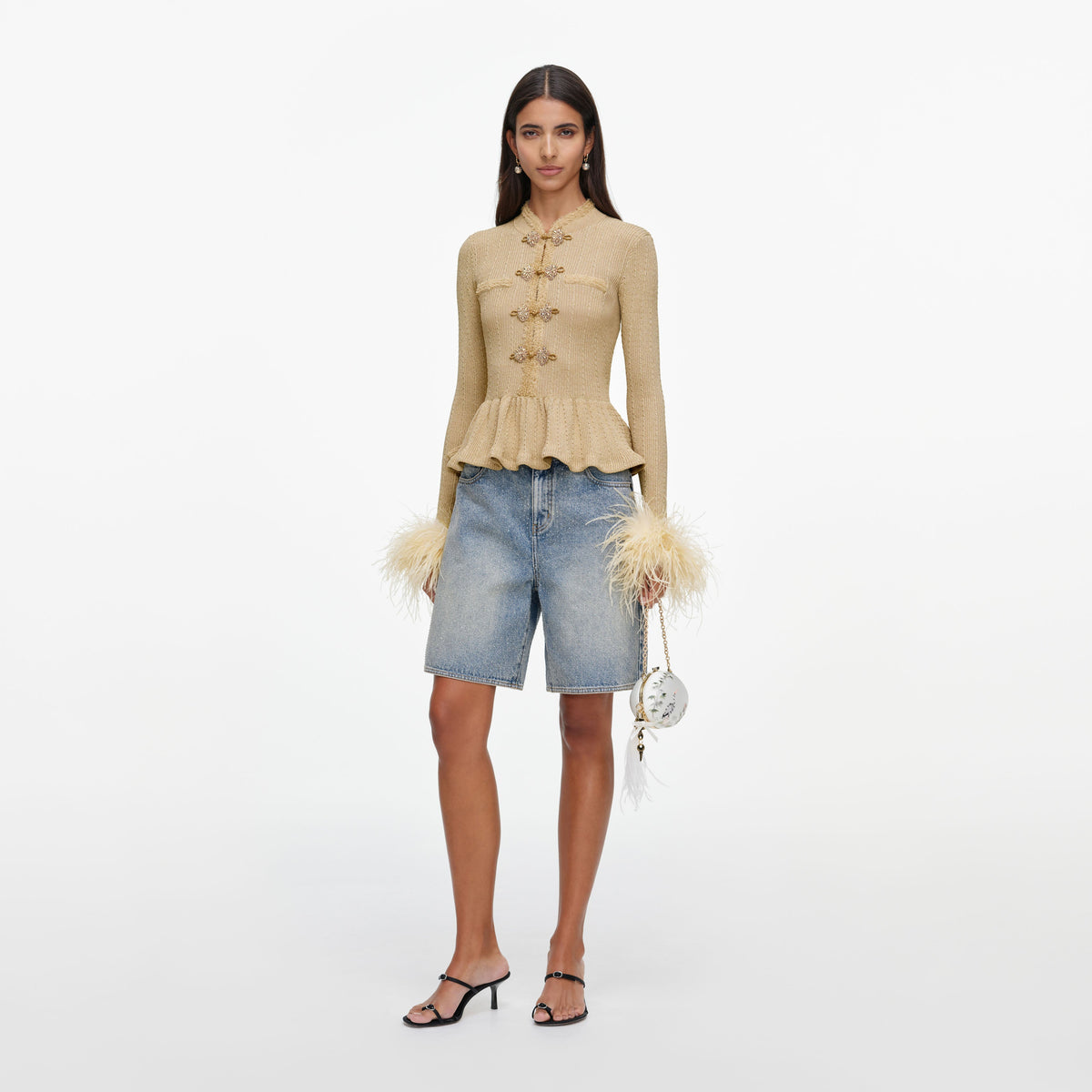 Side view of a woman wearing the Gold Metallic Feather Knit Top