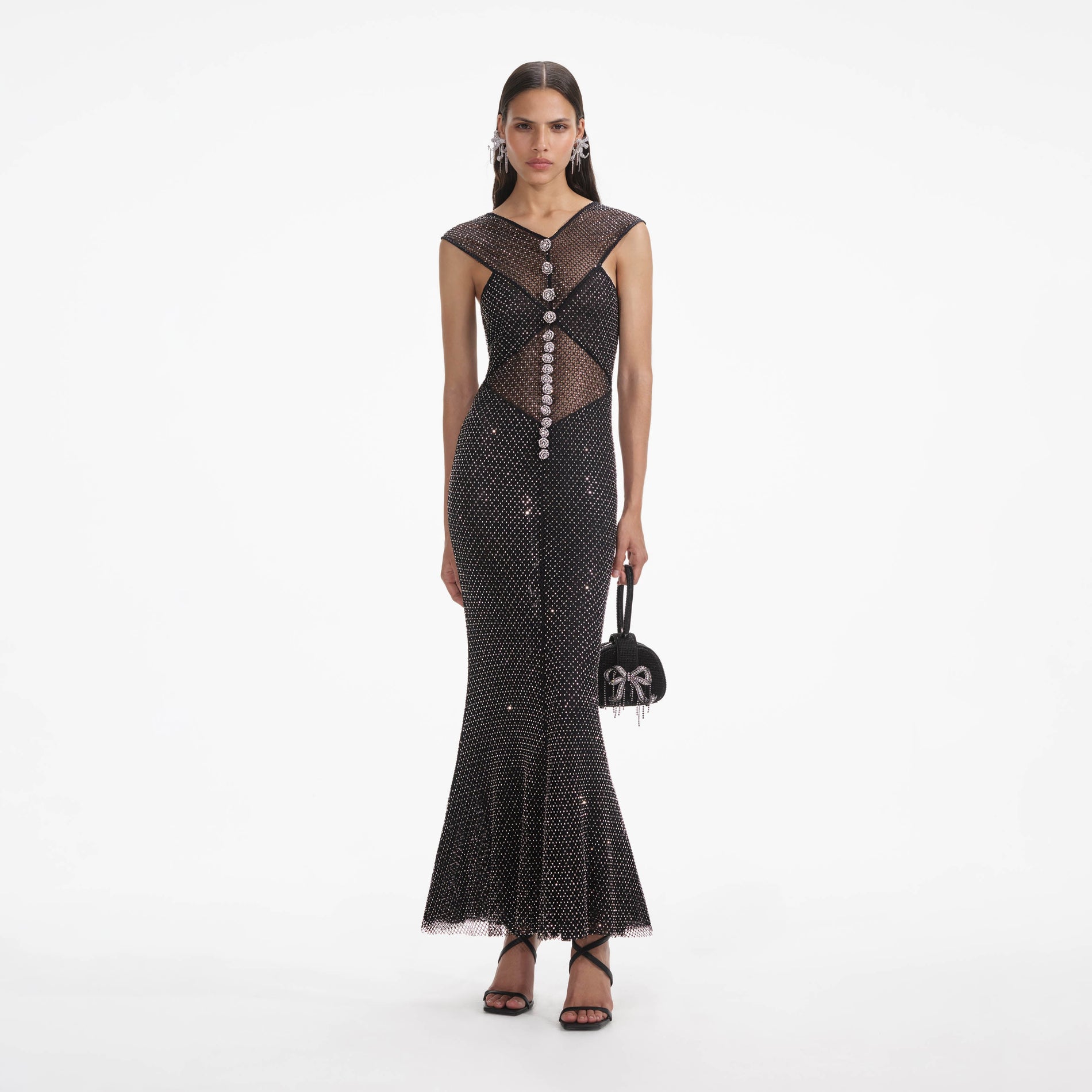 Front view of a woman wearing the Black Rhinestone Fishnet Crossover Midi Dress