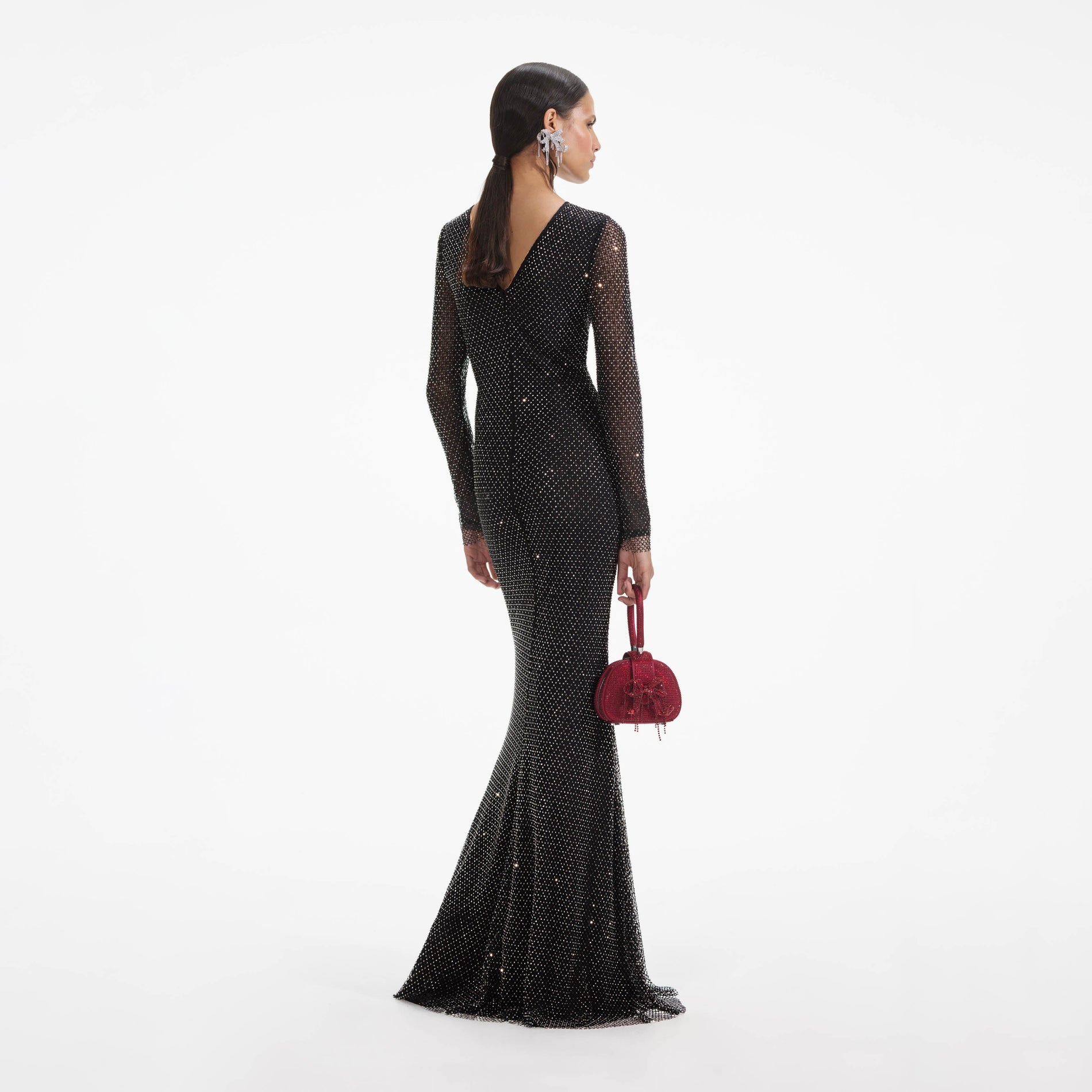 Back view of a woman wearing the Black Rhinestone Fishnet Crossover Maxi Dress