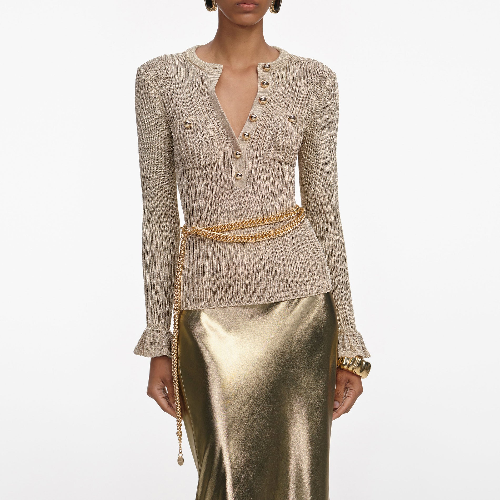 A close up of a woman wearing the Gold Metallic Maxi Skirt