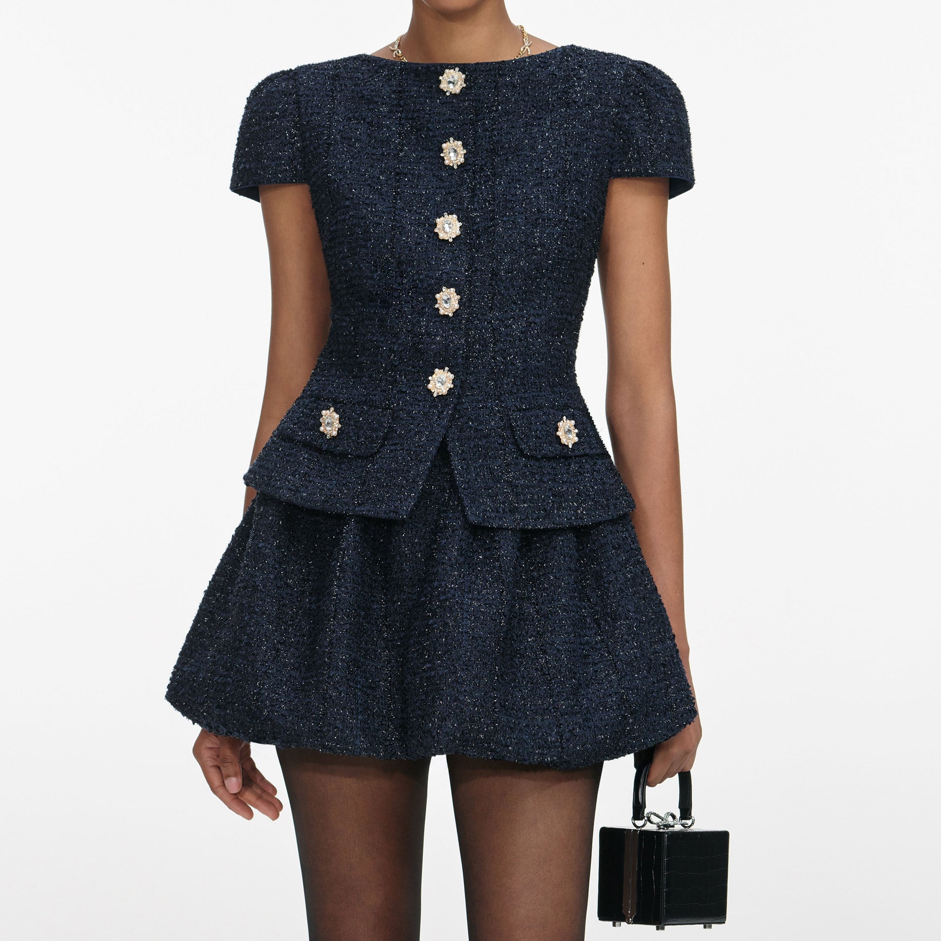 A close up of a woman wearing the Navy Boucle Mini Dress