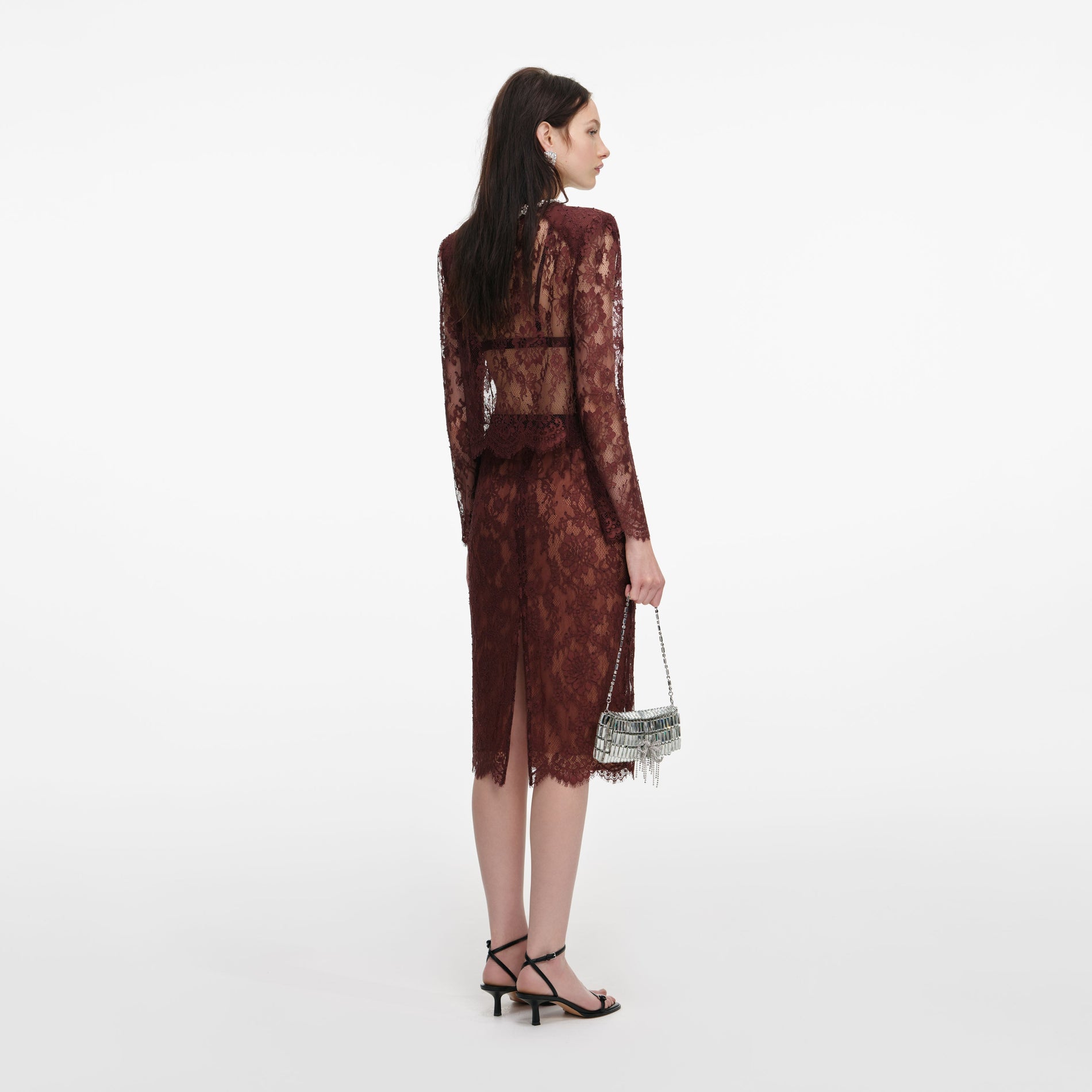 Back view of a woman wearing the Brown Floral Lace Midi Skirt